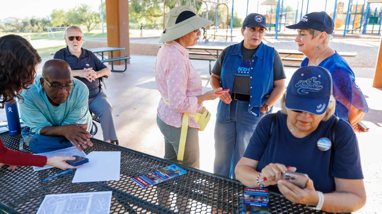 JoAnna Mendoza, a Democratic House hopeful in Arizona, with volunteers in Oro Valley, Arizona, on Oct. 15. Latinos backing Democratic House hopefuls are more engaged this cycle than those backing Republicans, a Pew study says