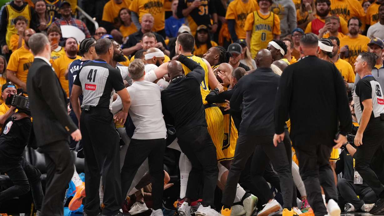 Players from the Dallas Mavericks and the Indiana Pacers scuffle after a hard foul during the first half of an NBA basketball game in Indianapolis, Friday, Oct. 23, 2026.