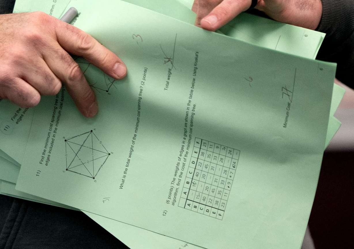 A teacher returns an exam at Jordan High School in Sandy on Jan. 15. The number of students in K-12 schools in Utah is declining.