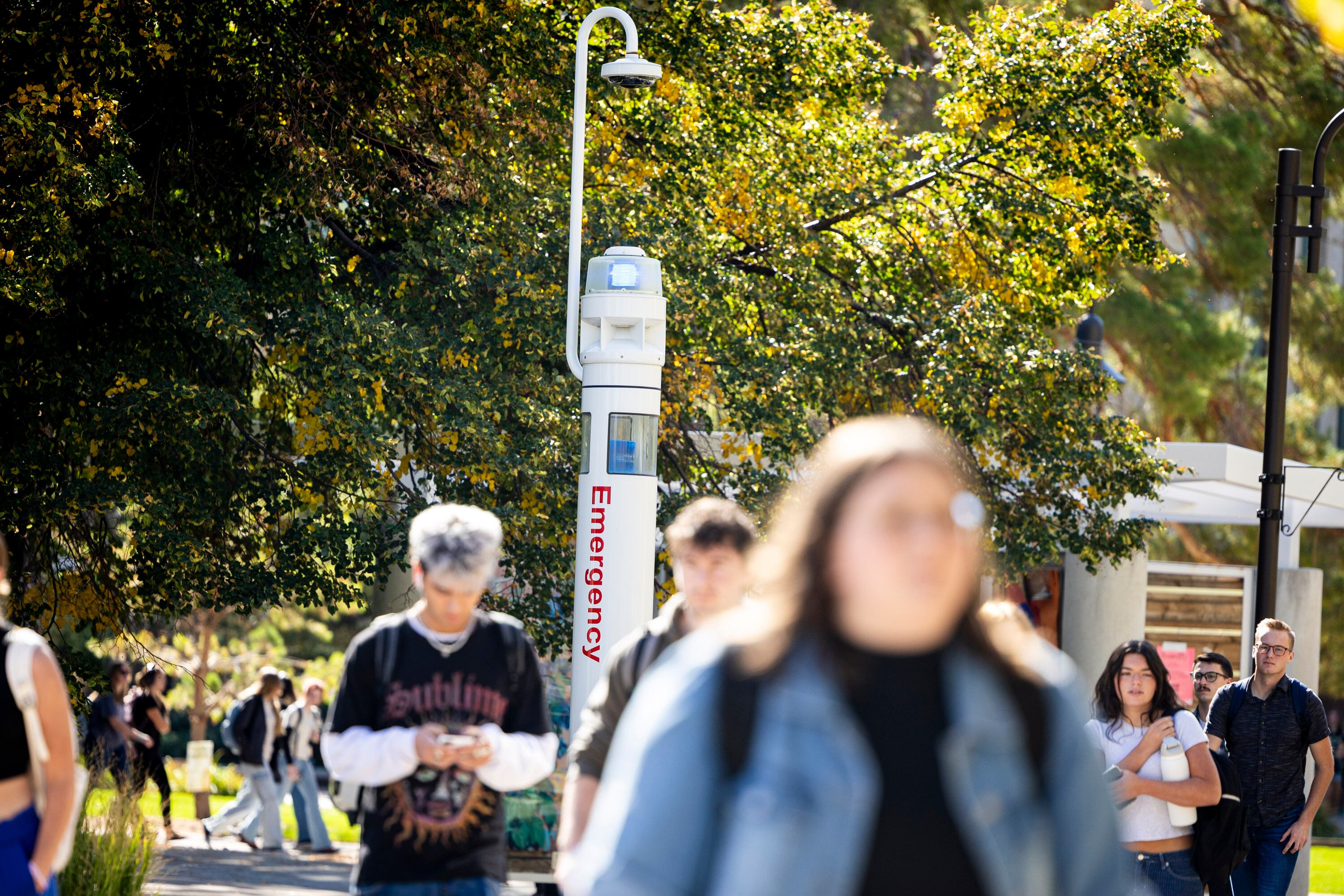 Students pass by an emergency terminal on the campus of Utah State University in Logan on Oct. 1, 2025. Higher education enrollment saw a slight increase but may decline soon, based on declining enrollment in Utah K-12 schools.
