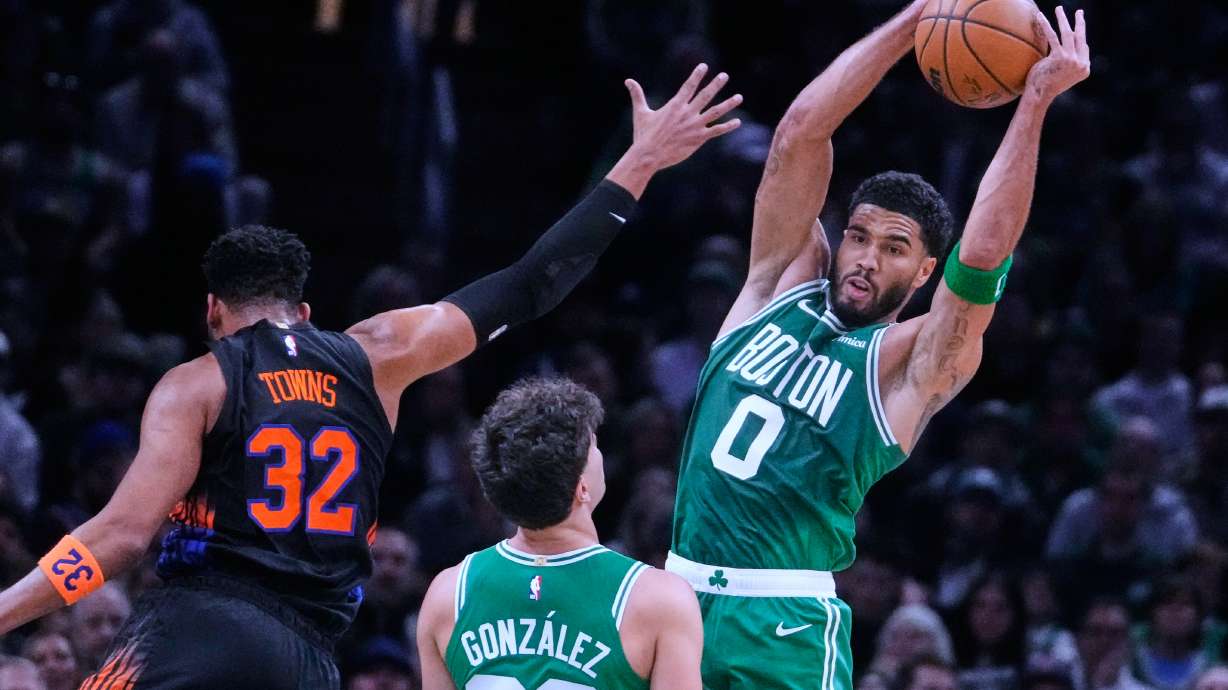 Boston Celtics' Jayson Tatum (0) grabs a rebound against New York Knicks' Karl-Anthony Towns (32) during the first half of an NBA basketball game, Friday, Oct. 23, 2026, in Boston.