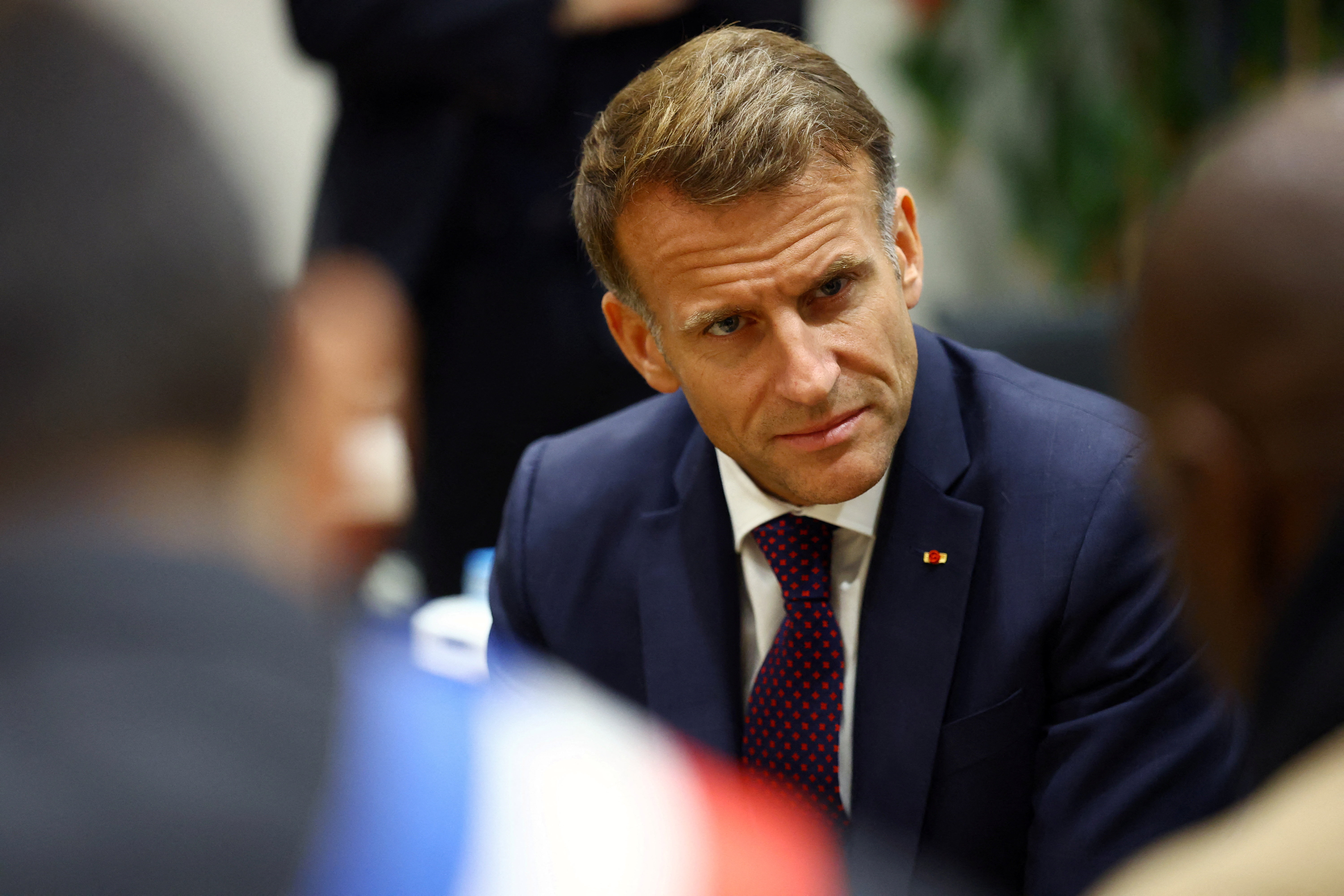 French President Emmanuel Macron meets community members at the town hall in Trappes, near Paris, Friday. Macron's authority is being challenged with protests over living costs and school funding, which saw over 400,000 protest nationwide on Saturday.