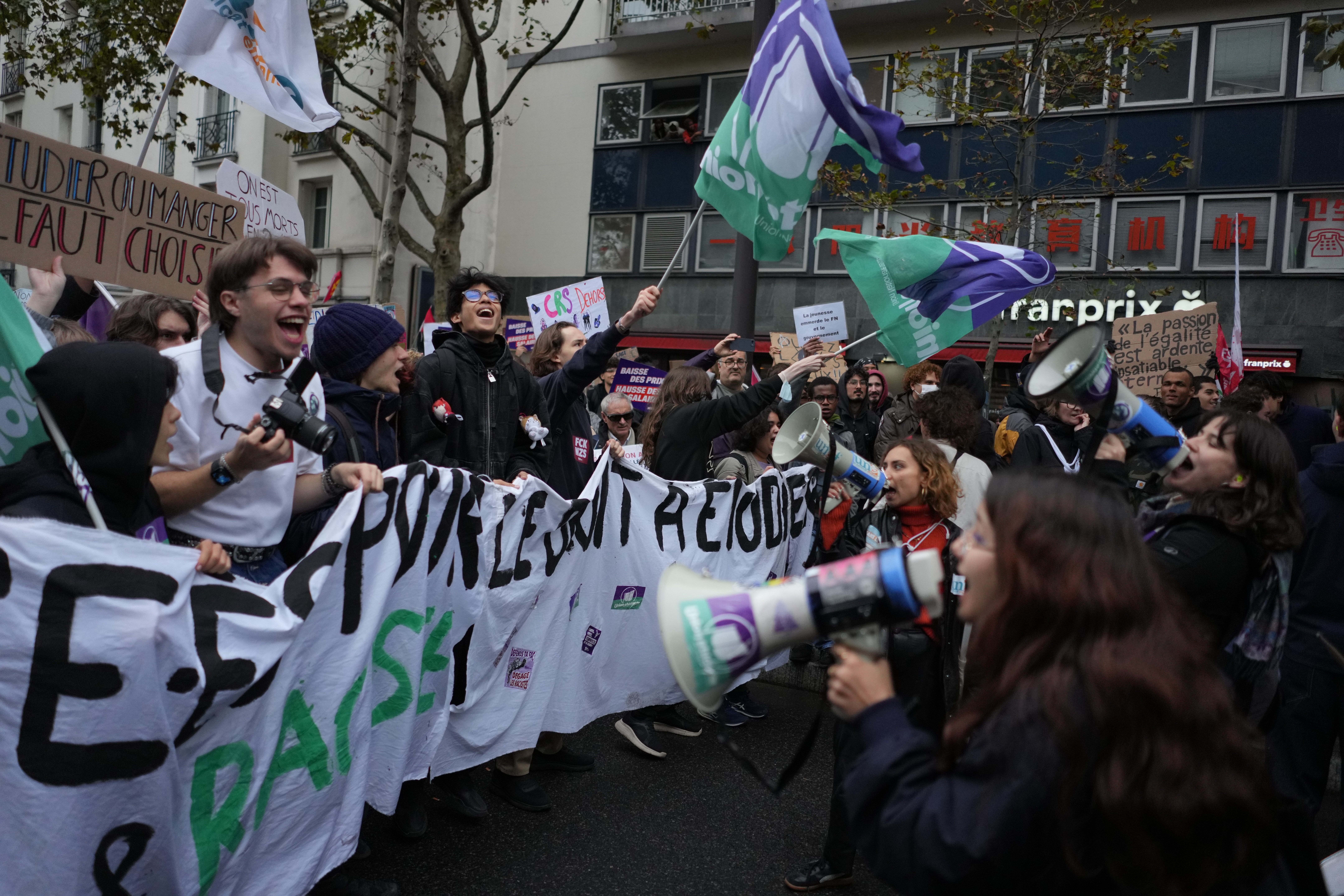 Students chant slogans during a demonstration against rising living costs in Paris, Saturday. Clashes erupted during the protests, with police making nearly 1,000 arrests.