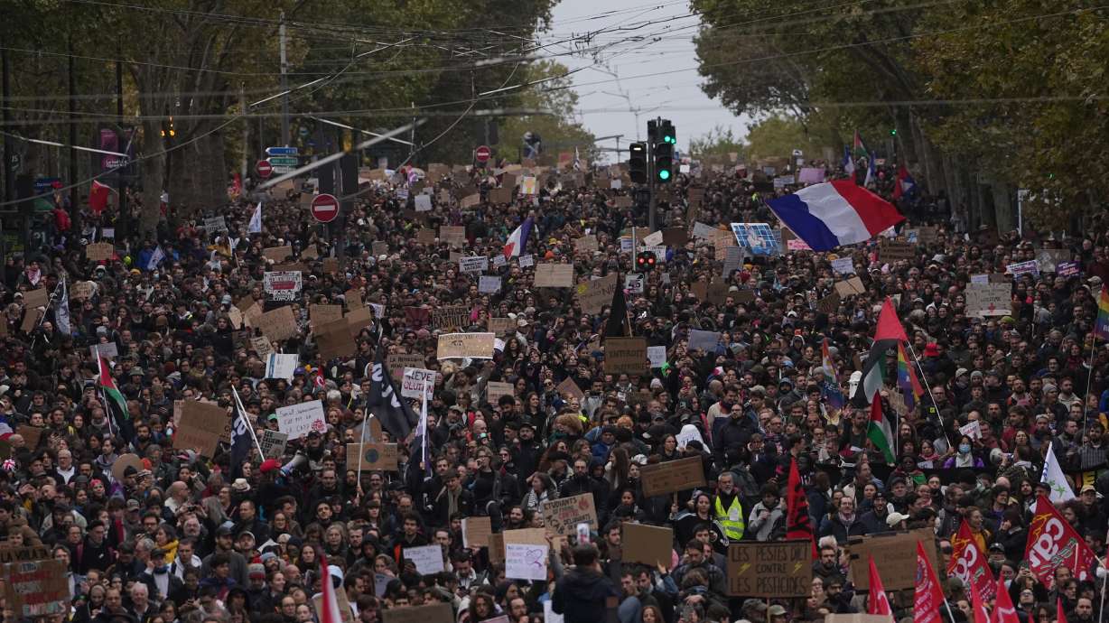 Protesters march during a demonstration against rising living costs in Paris, Saturday. Clashes erupted during the protests, with police making nearly 1,000 arrests.