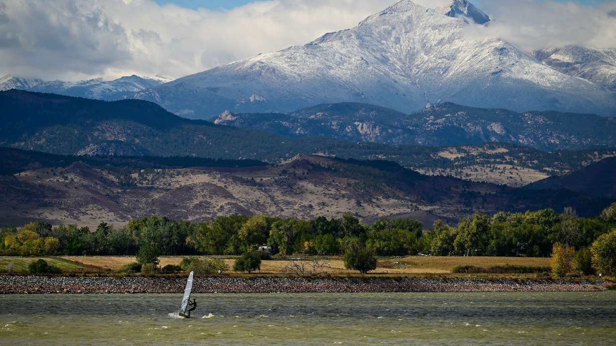 A windsurfer cuts across McIntosh Lake in front of the snow covered peaks of Mount Meeker and Longs Peak in Longmont, Colo., Oct. 15. A new CNN Weather analysis offered clues for who could see more snow during this year's El Nino.