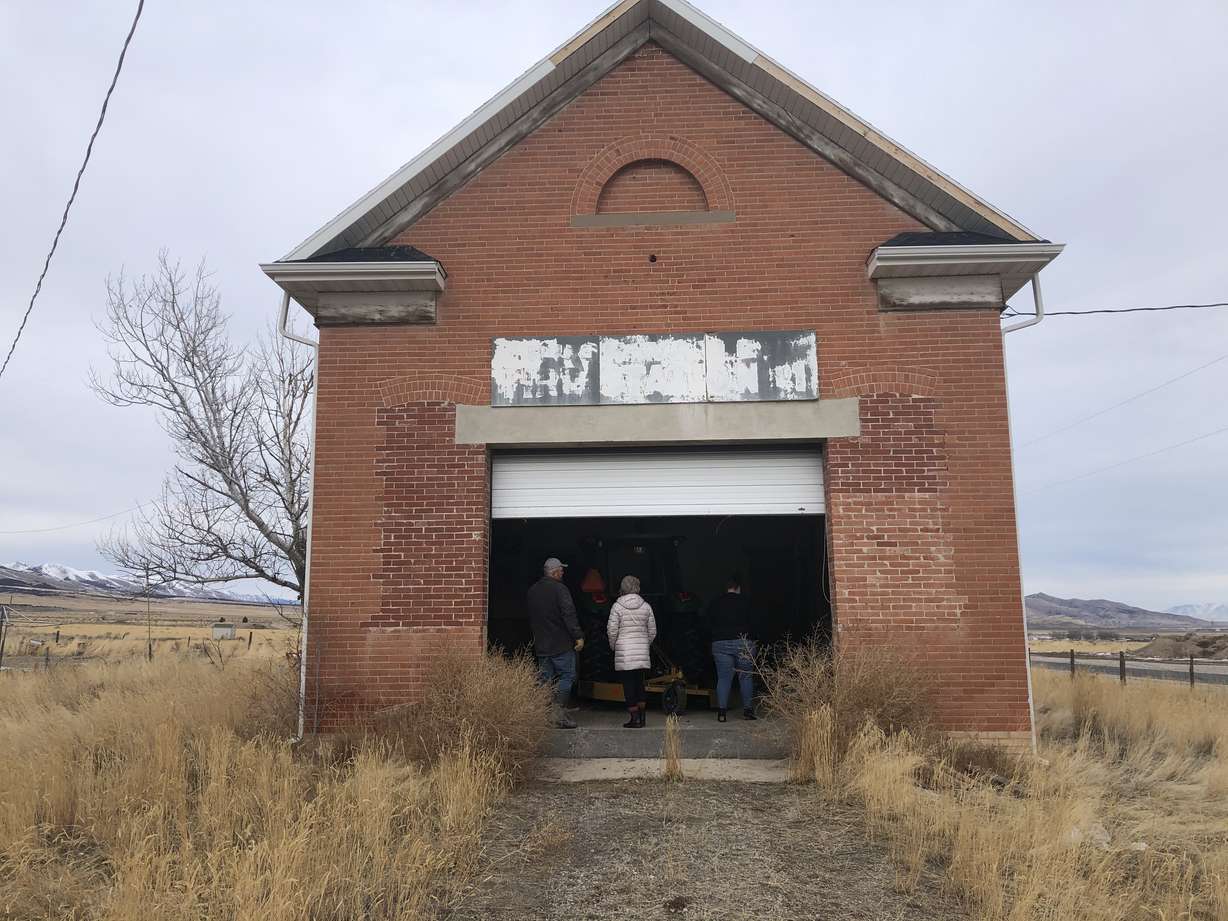 Volunteers enter the "Clover Ward LDS Meetinghouse" in 2021 as they prepare to begin renovations.