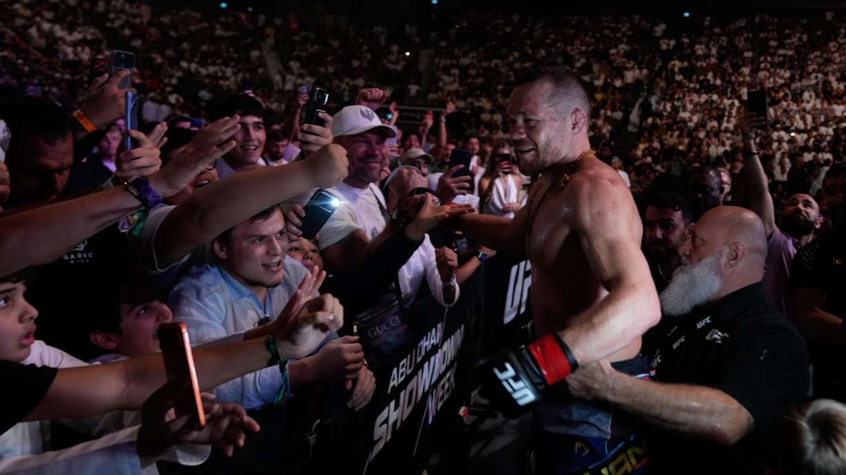 Russia's Petr Yan, right, celebrates with his fans after beating Merab Dvalishvili of Georgia to win the Bantamweight title bout at the mixed martial arts UFC Fight Night on Saturday, Oct. 24, 2026.