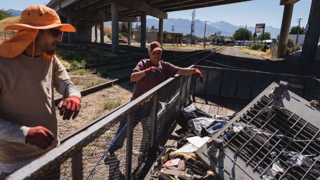 Advantage Services employees Max Loveridge and Anthony Tarchick clean up abandoned property called in by a police officer in Salt Lake City on Aug. 25. The social enterprise nonprofit is in danger of shutting down at the end of the month.