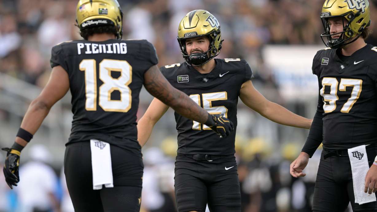 Central Florida kicker Will Stone (15) is congratulated by Caden Piening (18) and Mason Denaburg (97) after kicking a 19-yard field goal during the first half of an NCAA college football game against BYU, Saturday, Oct. 24, 2026, in Orlando, Fla.