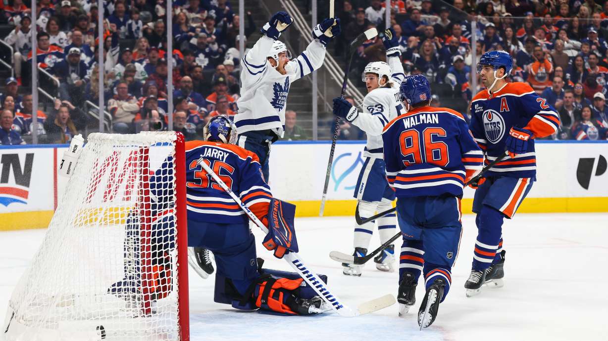 Toronto Maple Leafs' Jack Roslovic, back left, and Easton Cowan (53) celebrate after Roslovic's goal against the Edmonton Oilers during the first period of an NHL hockey game in Edmonton, Alberta, Saturday, Oct. 24, 2026.