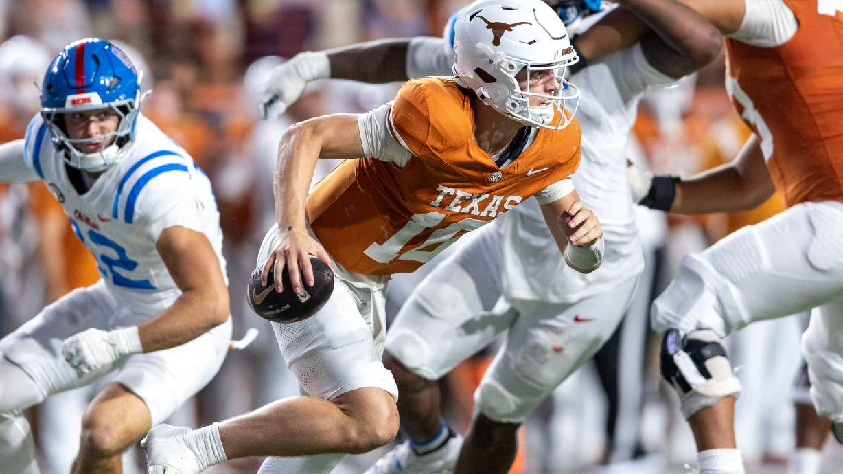 Texas quarterback Arch Manning (16) escapes pressure by Mississippi linebacker Luke Ferrelli, left, during the second half of an NCAA college football game in Austin, Texas, Saturday, Oct. 24, 2026.