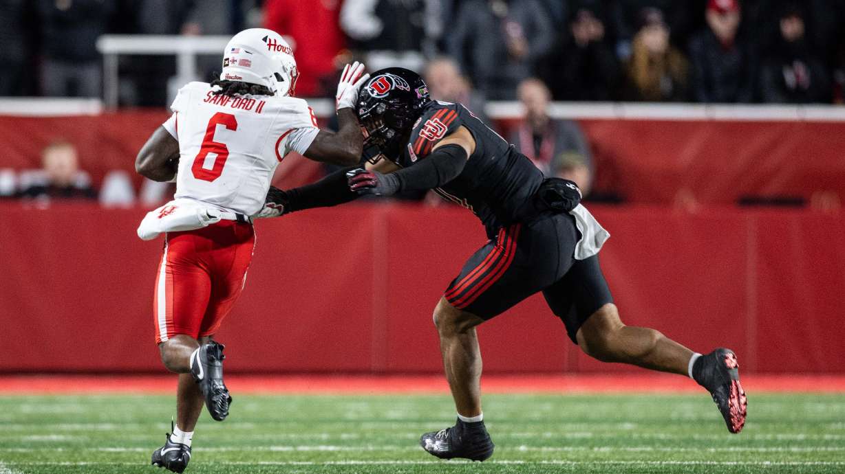 Houston Cougars running back Re'shaun Sanford II (6) tries to stiff arm a Utah defender during a game at Rice-Eccles Stadium in Salt Lake City Saturday, Oct. 24, 2026.