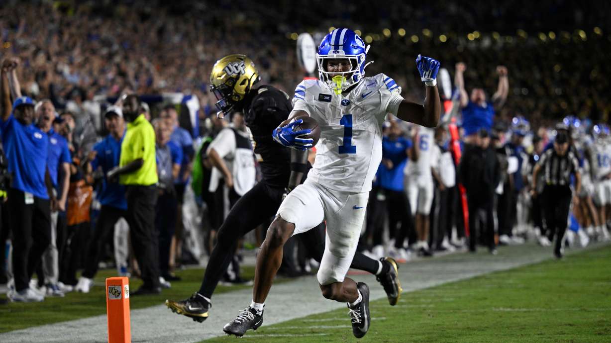BYU wide receiver Legend Glasker (1) scores a touchdown past Central Florida cornerback Jayden Williams (2) during the first overtime period of an NCAA college football game, Saturday, Oct. 24, 2026, in Orlando, Fla.