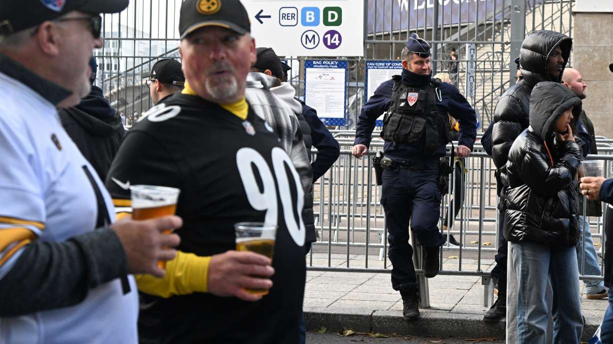 A police officer stands outside the Stade de France stadium before the start of the NFL football game between Pittsburgh Steelers and New Orleans Saints in Saint-Denis, outside Paris, Sunday, Oct. 25, 2026.