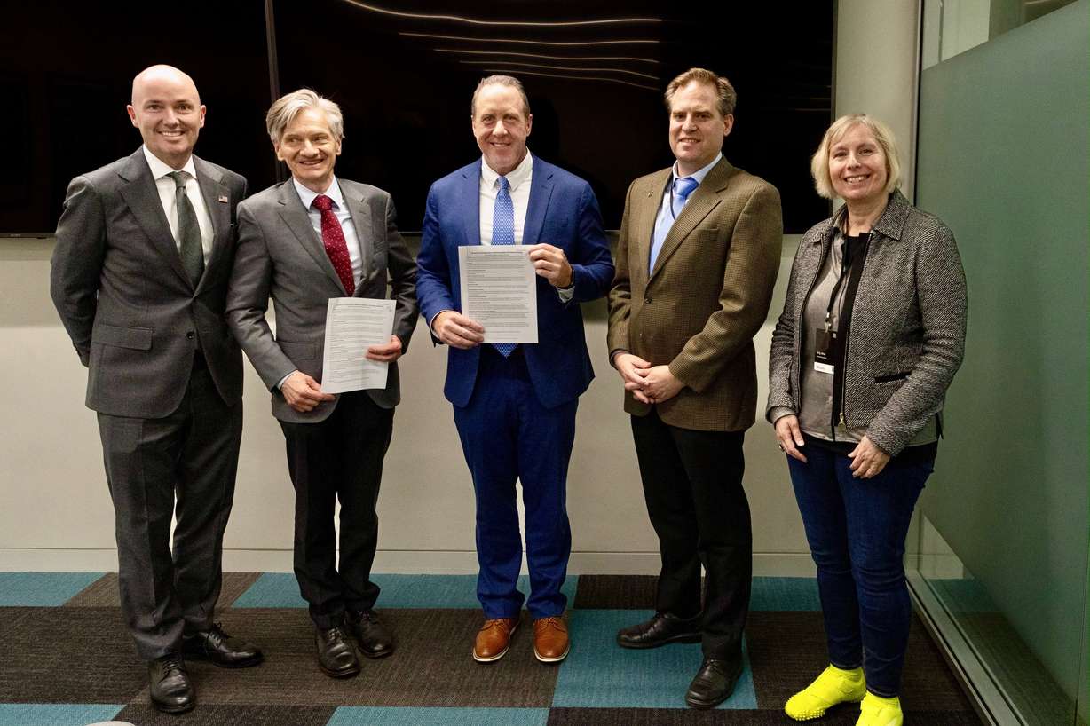 From left to right, Utah Gov. Spencer Cox; professor Ortwin Hess, co-director of Rinn Quantum at Trinity College; Jefferson Moss, executive director of the Governor's Office of Economic Opportunity; BYU professor Ryan Camacho; and University of Utah professor Orly Alter sign a memorandum of understanding on quantum technology research at Trinity College in Dublin on Oct. 21.