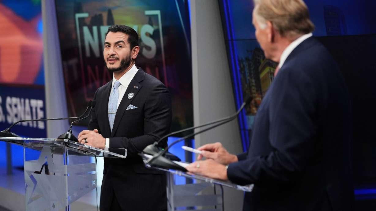 Democratic nominee for U.S. Senate Abdul El-Sayed, left, looks over to Republican nominee for U.S. Senate Mike Rogers during a televised debate at WOOD-TV, on Oct. 8, in Grand Rapids, Mich.