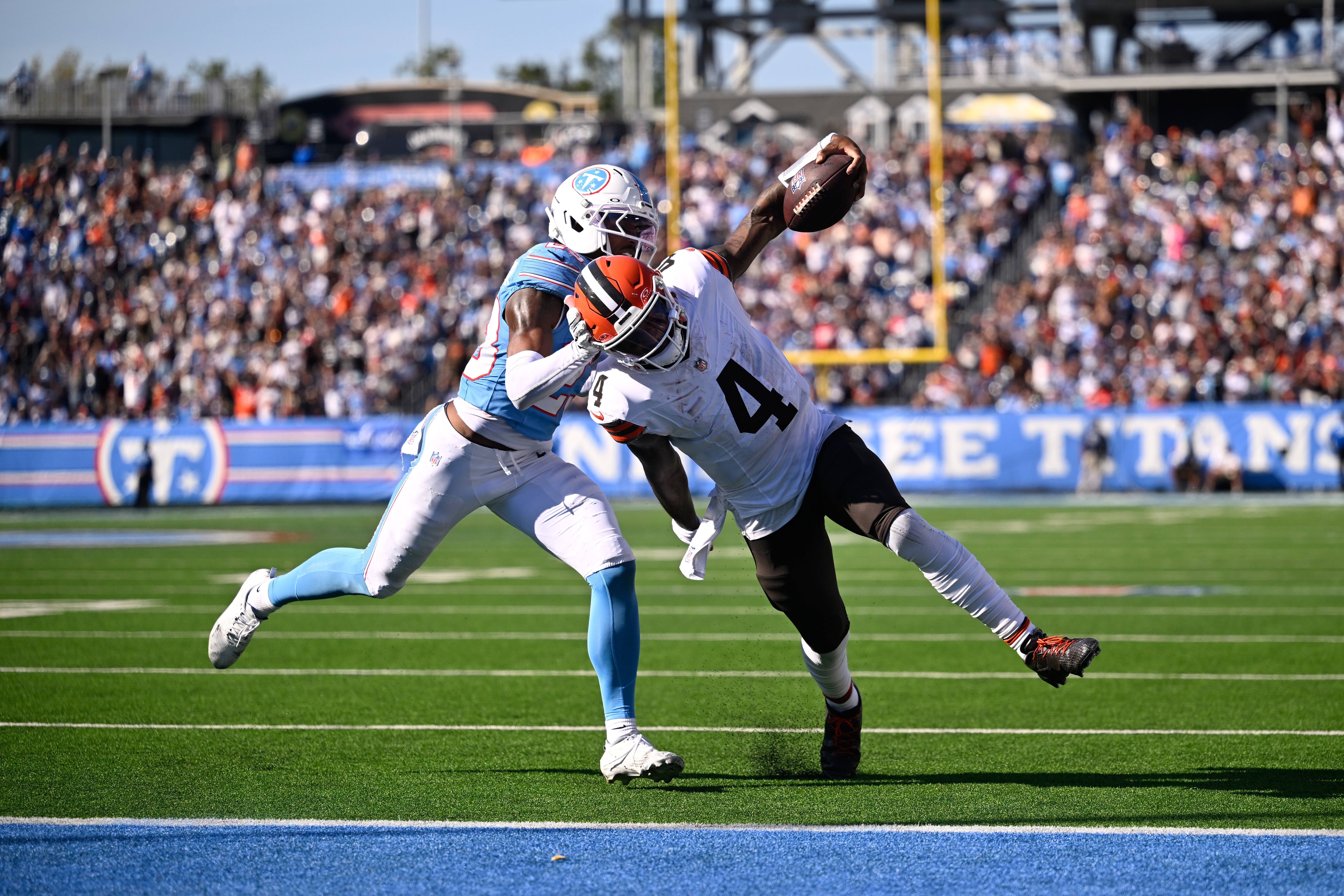 Cleveland Browns quarterback Deshaun Watson (4) scores a touchdown past Tennessee Titans safety Kevin Winston Jr. (23) during the second half of an NFL football game in Nashville, Tenn., Sunday, Oct. 25, 2026. 