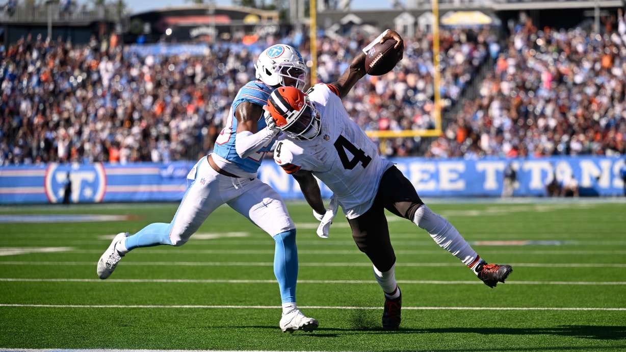 Cleveland Browns quarterback Deshaun Watson (4) scores a touchdown past Tennessee Titans safety Kevin Winston Jr. (23) during the second half of an NFL football game in Nashville, Tenn., Sunday, Oct. 25, 2026.