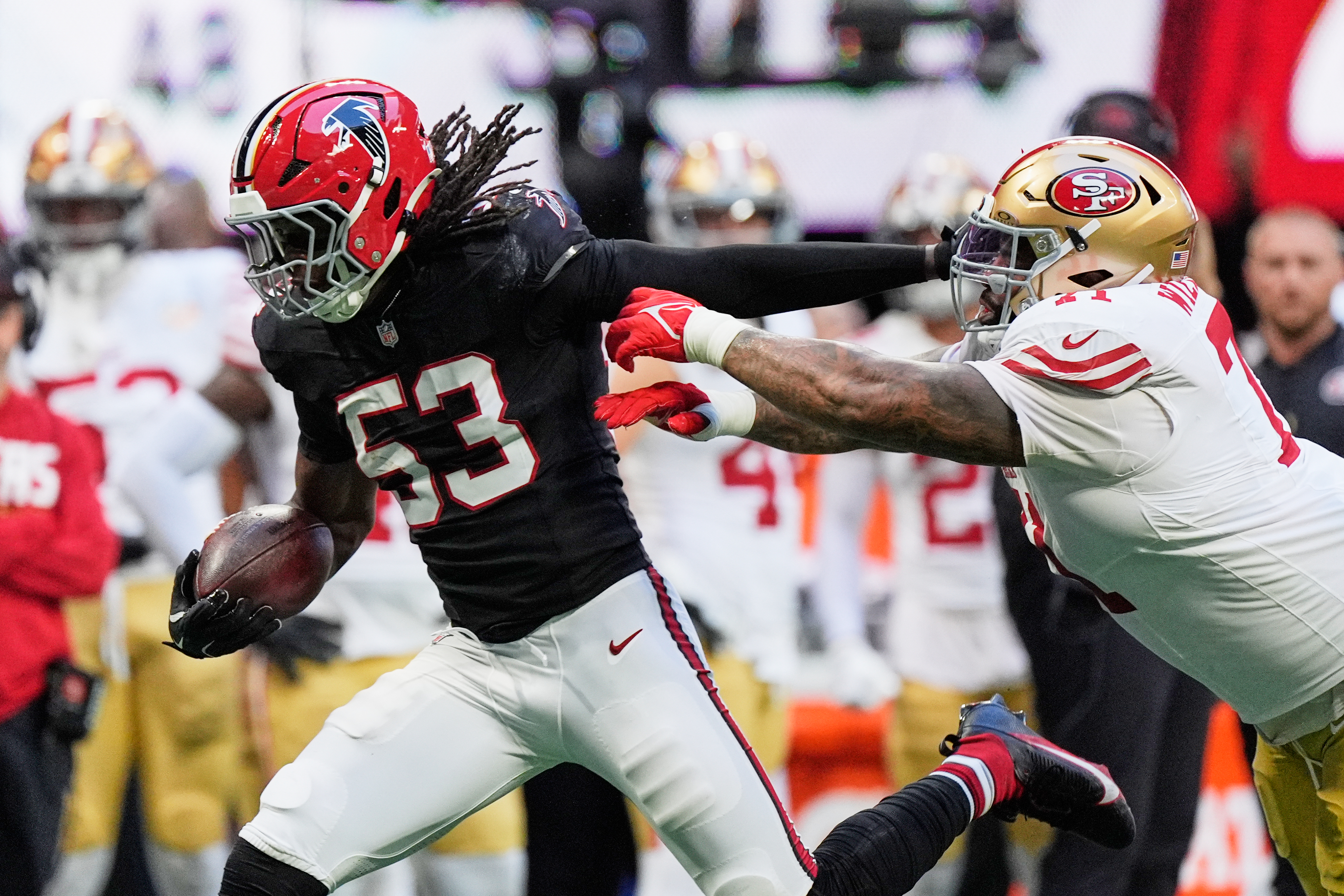 Atlanta Falcons linebacker Kendal Daniels (53) returns an interception as San Francisco 49ers offensive tackle Trent Williams, right, makes the stop during the second half of an NFL football game in Atlanta, Sunday, Oct. 25, 2026. 