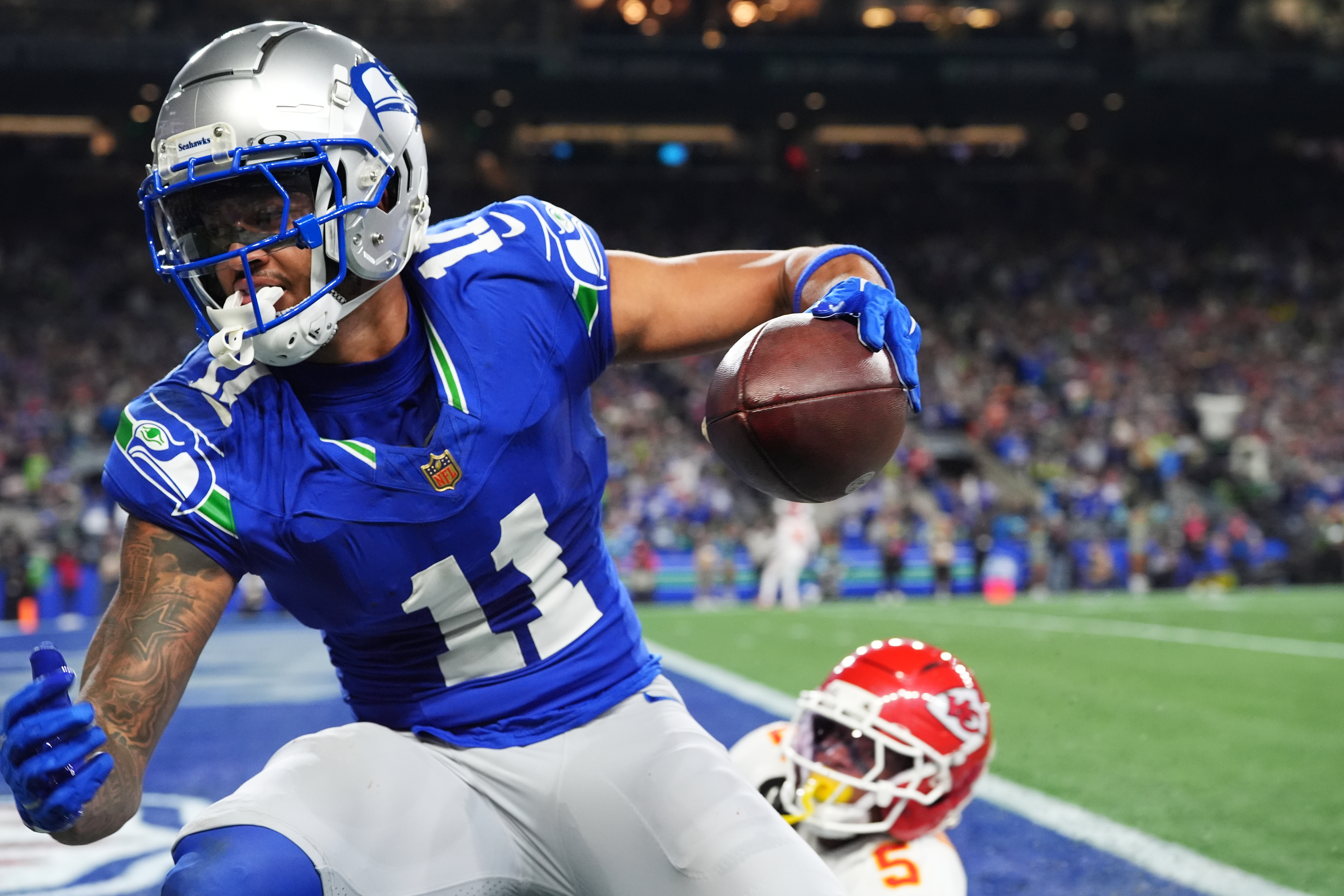 Seattle Seahawks wide receiver Jaxon Smith-Njigba (11) reacts after a catch for a touchdown in front of Kansas City Chiefs cornerback Mansoor Delane (5) during the first half of an NFL football game in Seattle, Sunday, Oct. 25, 2026. 