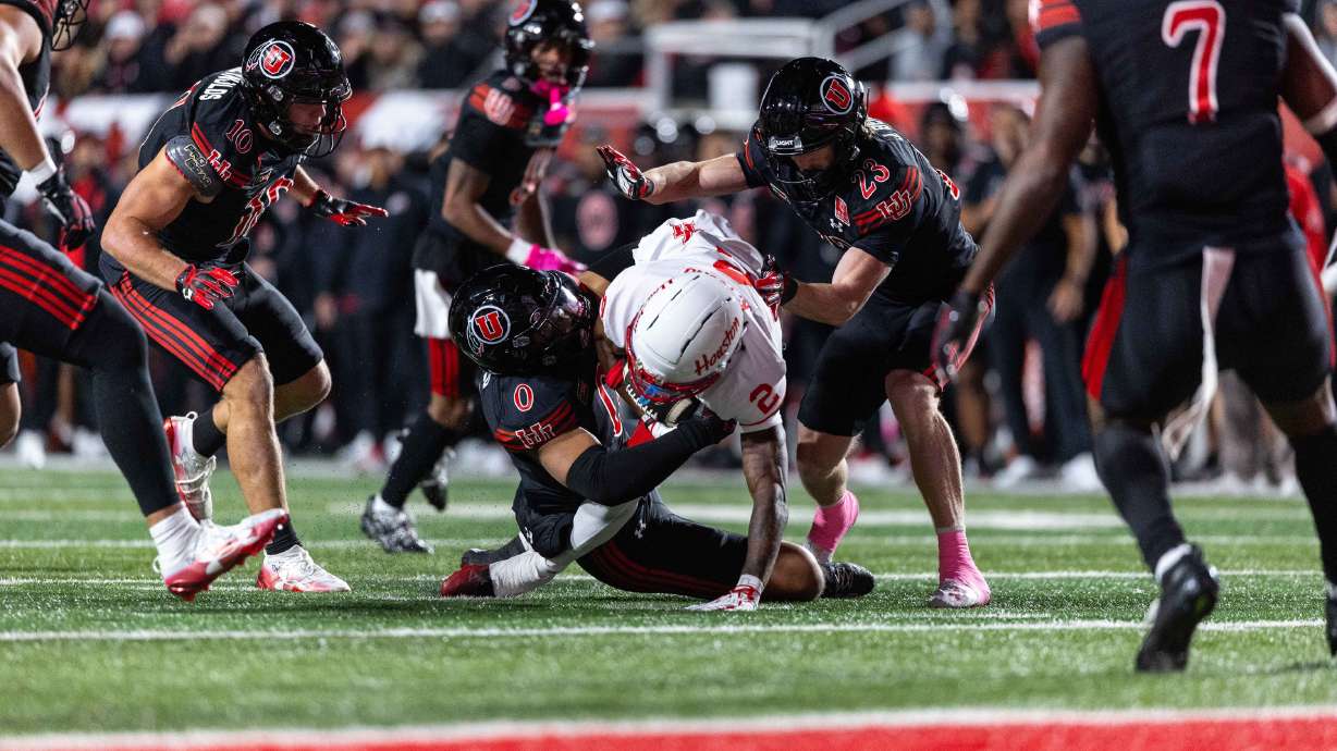 Utah defenders swarm Houston Cougars wide receiver Koby Young (2) during a game at Rice-Eccles Stadium in Salt Lake City on Saturday, Oct. 24, 2026.