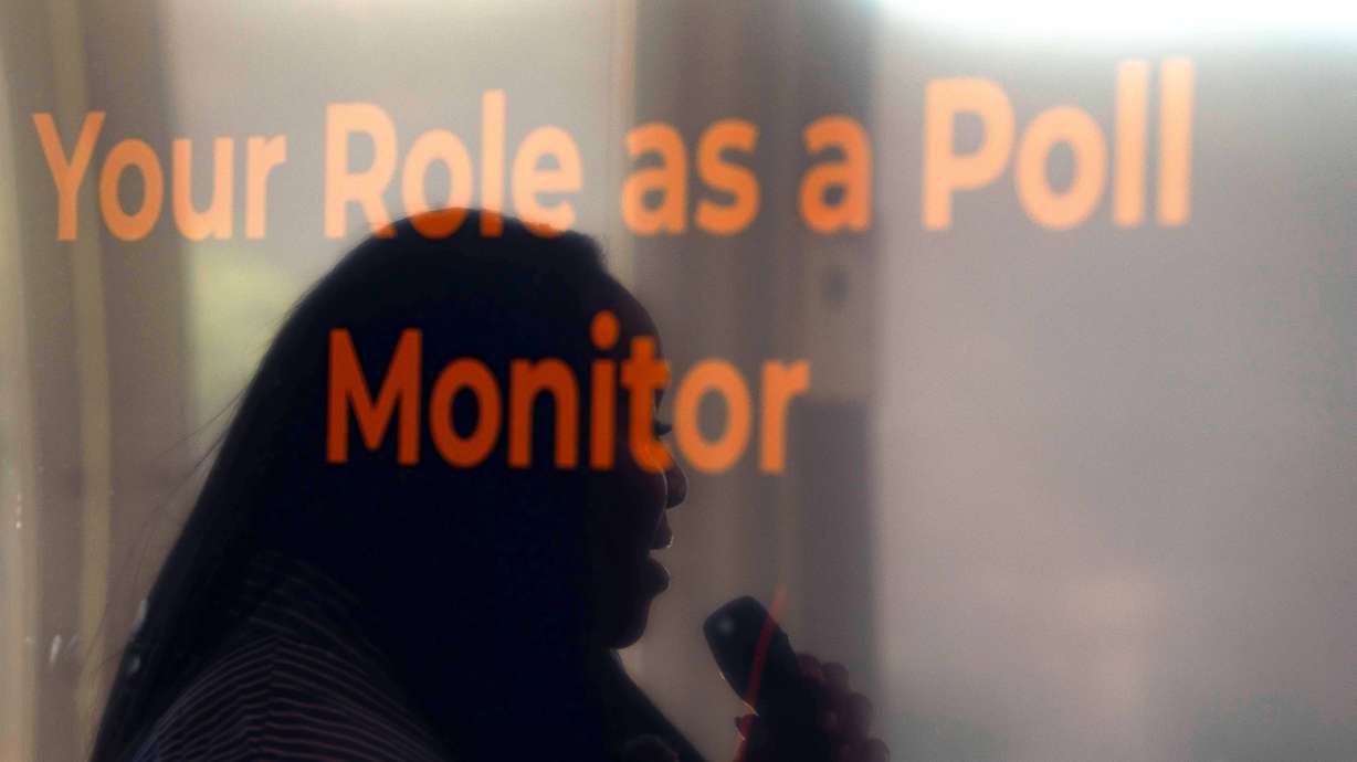 Rev. Medina Moore, an Arizona Faith Network voting rights organizer, is reflected on a television screen during a training for poll chaplains and peacekeepers, Tuesday, Oct. 6, 2026, ahead of the upcoming general midterm election, at Temple Chai in Scottsdale, Ariz.