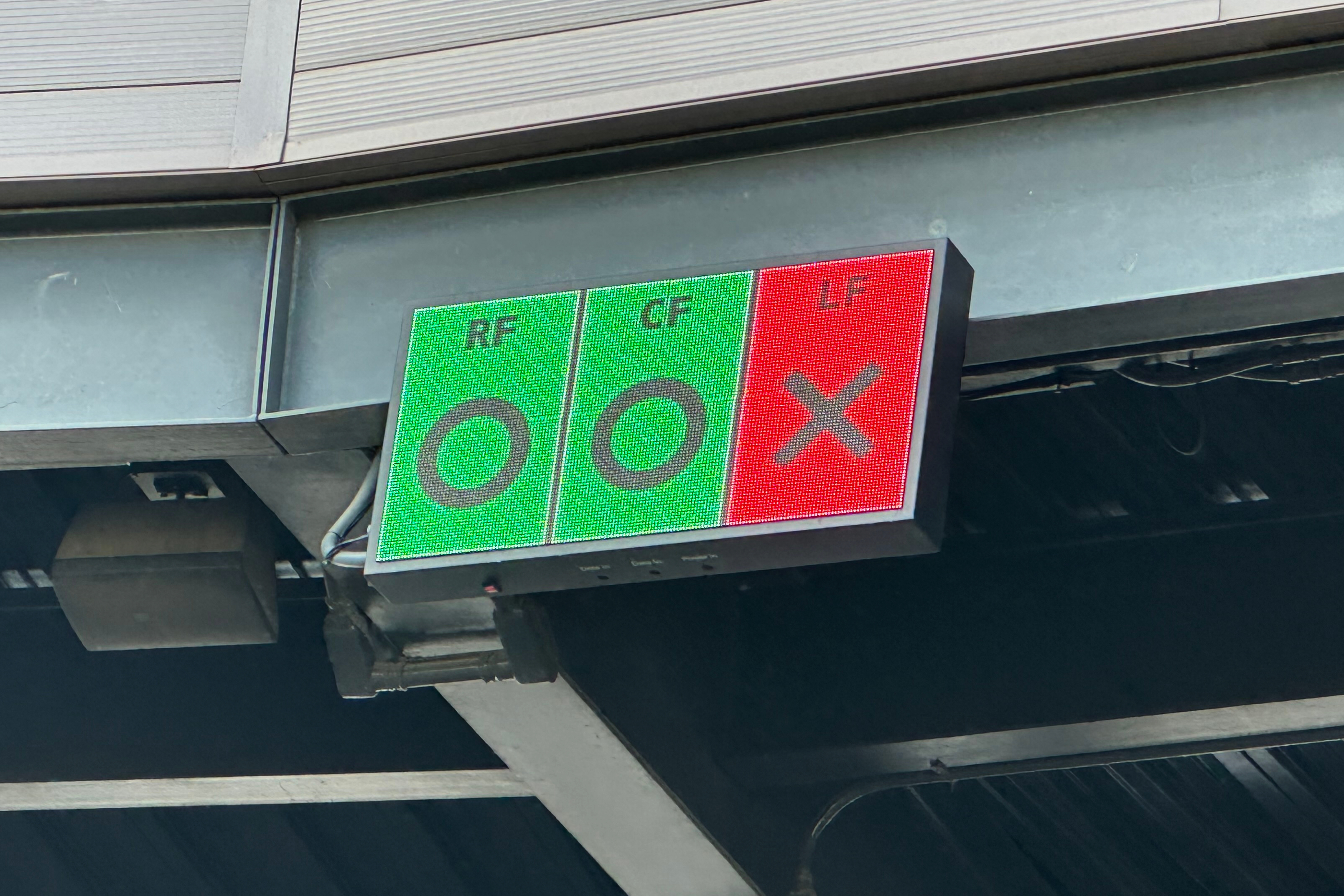 In this photo taken with a smartphone, a video board above home plate at Salt River Fields shows outfielders if they are in the correct Thursday, Oct. 22, 2026, in Scottsdale, Ariz. 