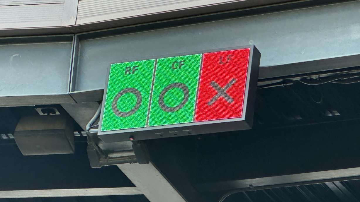 In this photo taken with a smartphone, a video board above home plate at Salt River Fields shows outfielders if they are in the correct Thursday, Oct. 22, 2026, in Scottsdale, Ariz.
