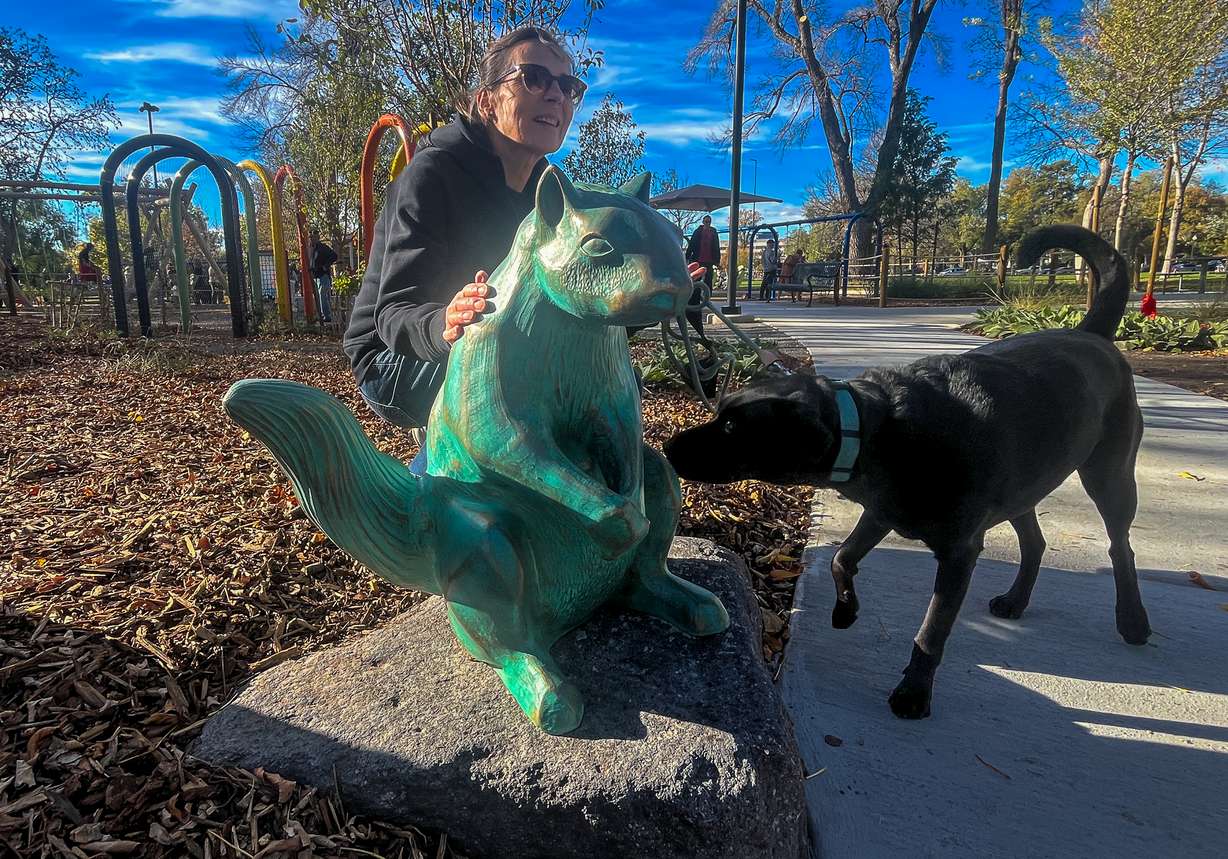 Lenka Konopasek poses with her sculpture, Woody at Liberty Park in Salt Lake City. The squirrel is the first of 20 smaller sculptures planned for parks across the city in the coming years.