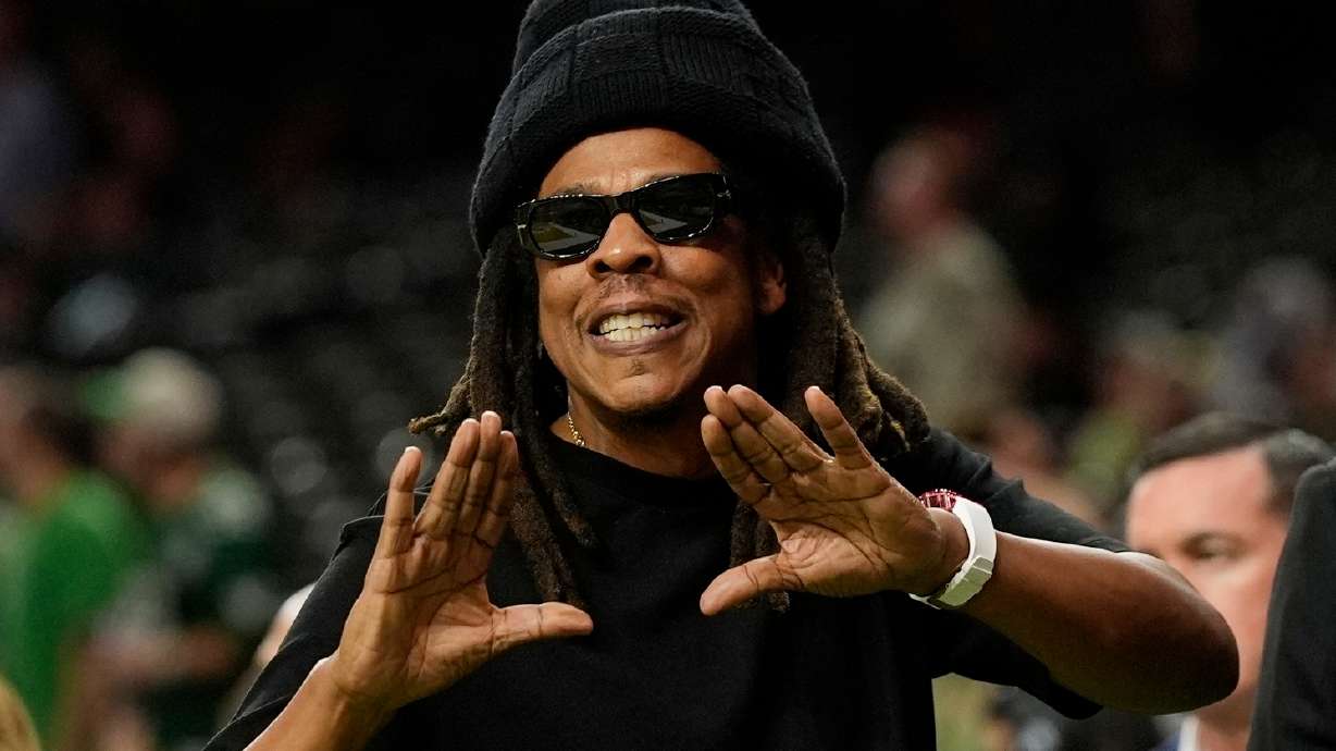 FILE - Jay-Z gestures from the sidelines prior to the NFL Super Bowl 59 football game, Feb. 9, 2025, in New Orleans.