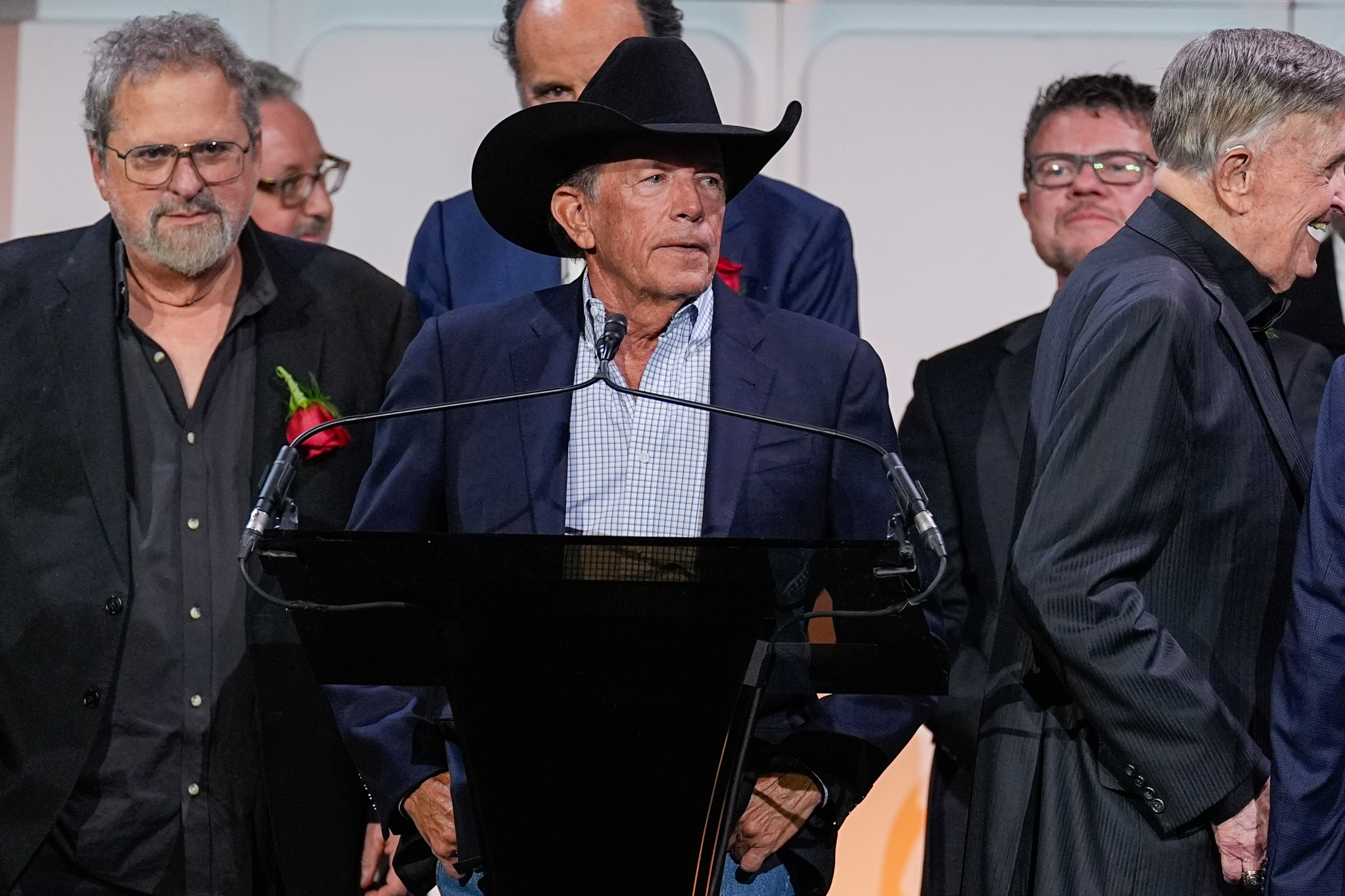 George Strait, center, speaks during the Nashville Songwriters Hall of Fame Gala on Monday at the Music City Center in Nashville, Tenn.