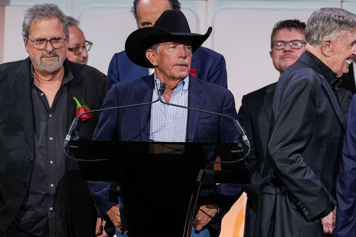 George Strait, center, speaks during the Nashville Songwriters Hall of Fame Gala on Monday at the Music City Center in Nashville, Tenn.