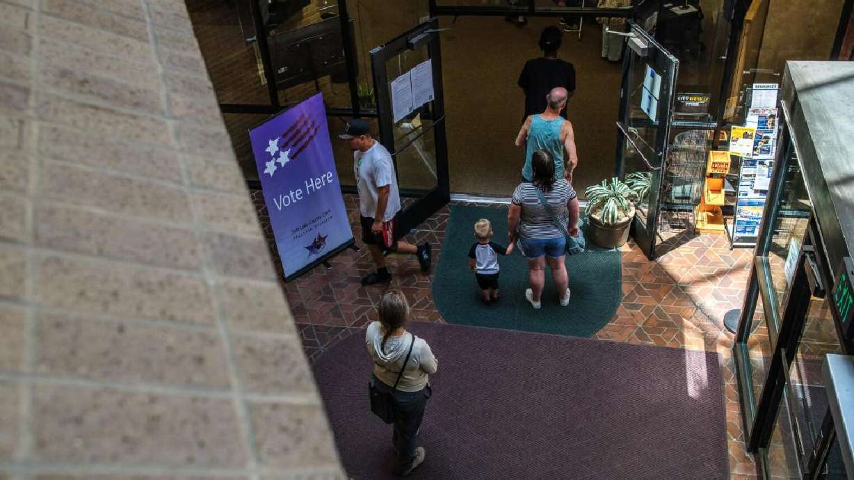 Voters wait in line on primary Election Day at the Salt Lake County Government Center on June 23.
