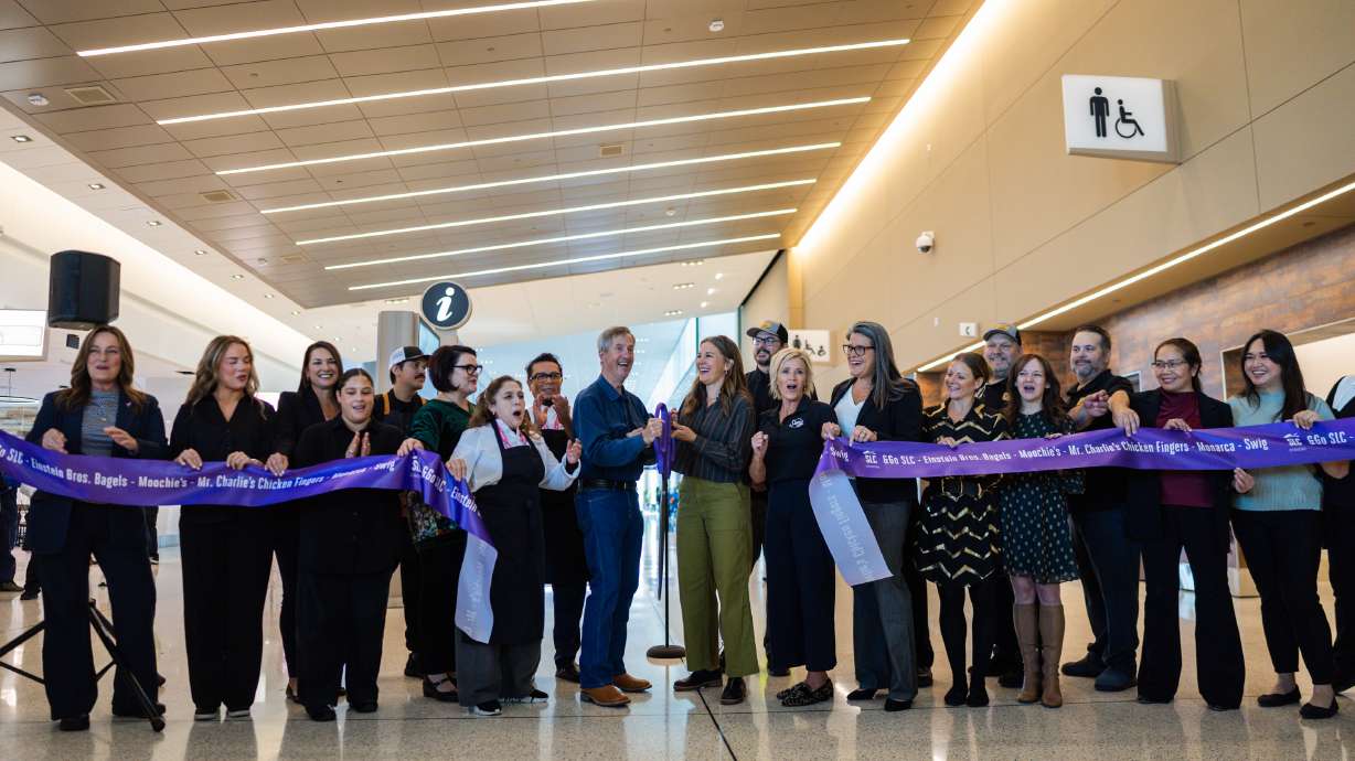 Community leaders, business owners and officials react after cutting the ribbon to celebrate the opening of the final seven gates and six concessions of the new SLC Redevelopment Program at the Salt Lake City International Airport in Salt Lake City on Tuesday.