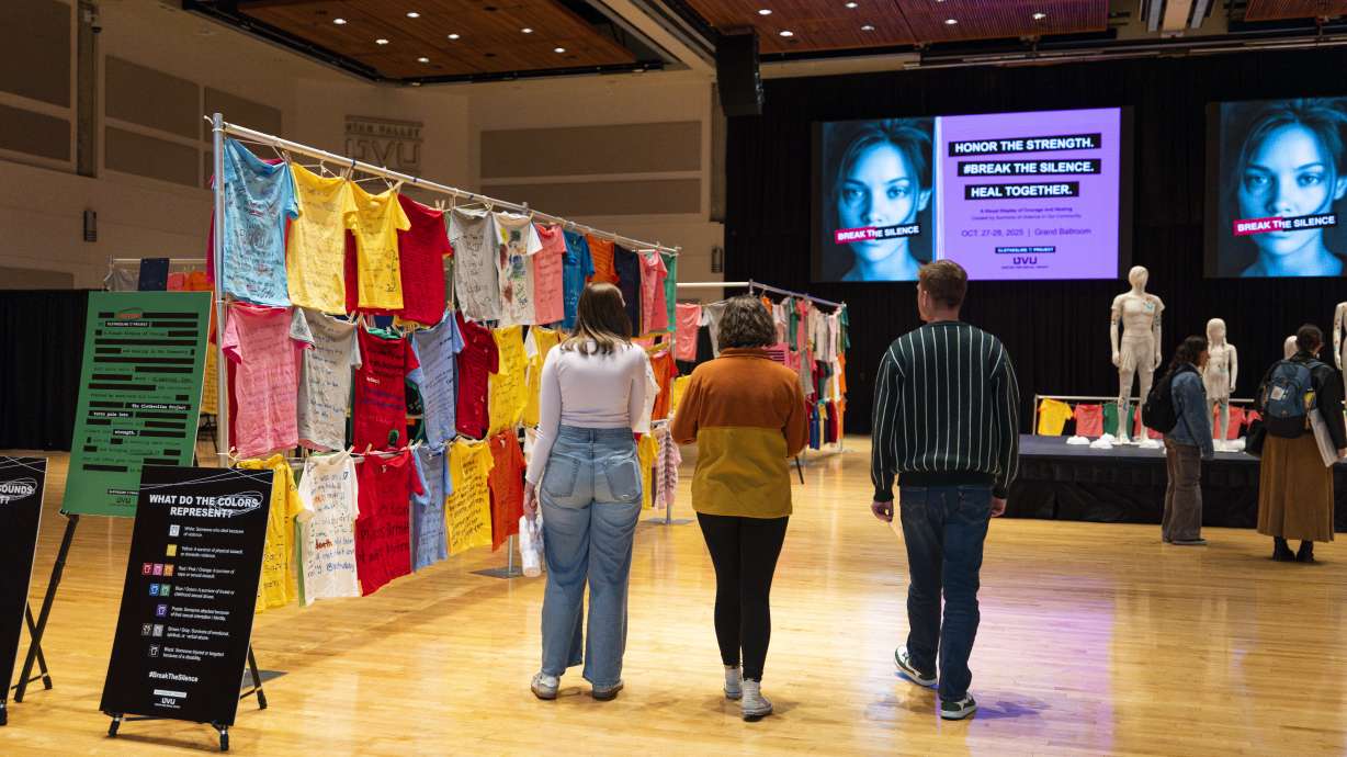 Visitors walk through Utah Valley University's annual Clothesline Project exhibit in Orem. The display features hundreds of shirts sharing stories of domestic violence, sexual assault and survival.
