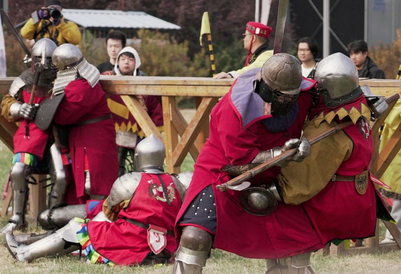 Spectators watch as participants dressed in historical plate armour fight during the Quanjia Fighting Open Championship, a full-contact medieval combat tournament in Beijing, China, October 24, 2026.