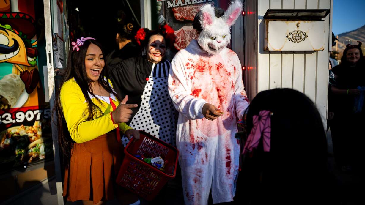 People trick-or-treat at Zacatecas Market during the Tooele City Downtown Halloween Trick-or-Treat Main Street in Tooele on Oct. 31, 2025. Attending local Halloween swaps or exchanging costumes can help reduce waste this season.
