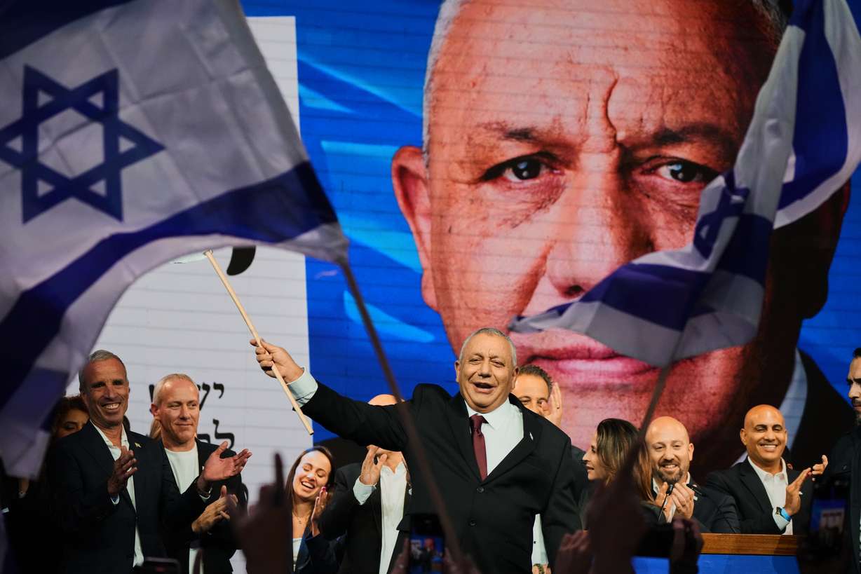 Gadi Eisenkot, leader of the Yashar ("Straight") party, waves an Israeli flag onstage following the release of the first exit poll results in Israel's general election in Tel Aviv, Israel, Wednesday.