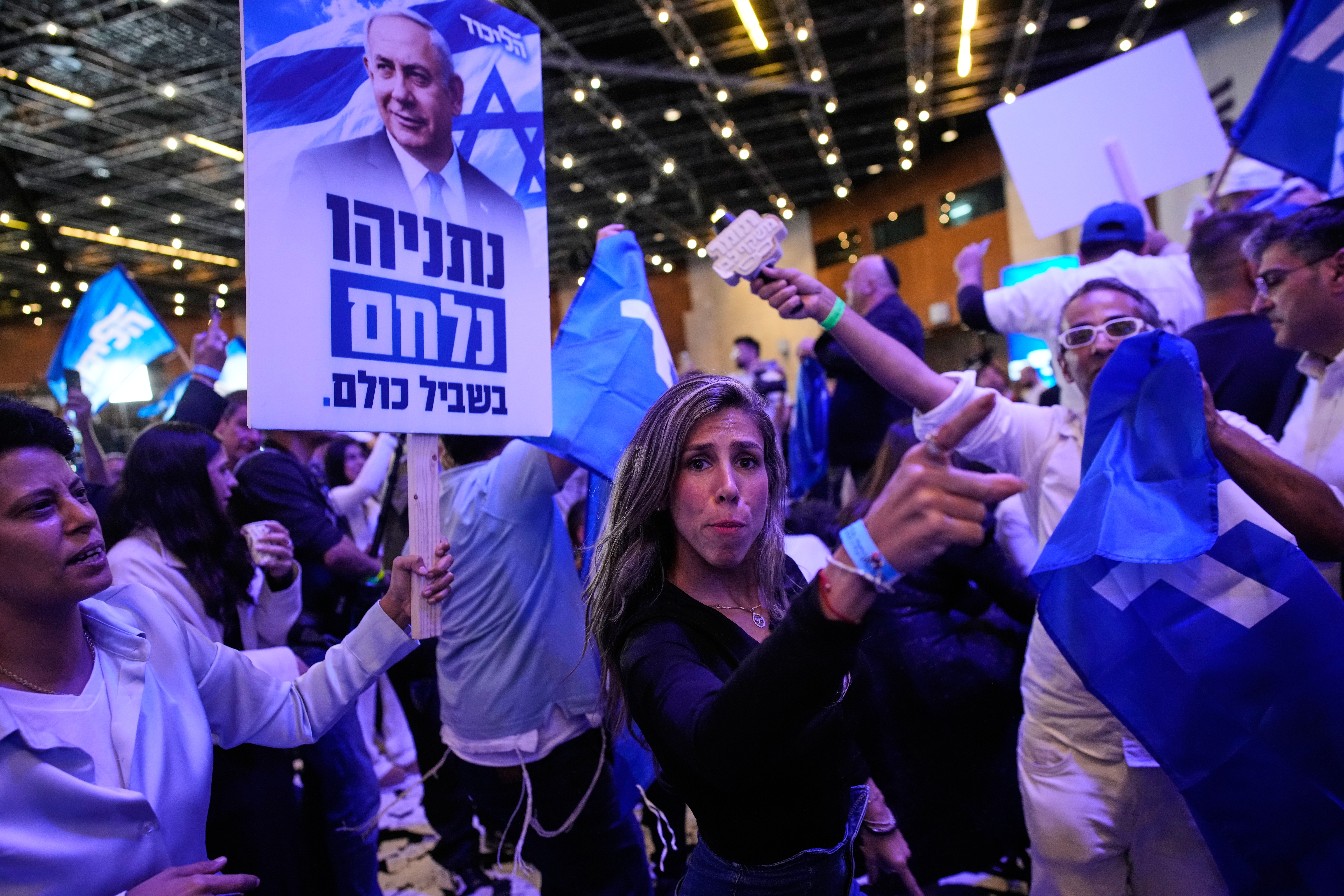 Supporters of Israeli Prime Minister Benjamin Netanyahu celebrate at Likud party headquarters in Jerusalem following the release of the first exit poll results in Israel's general election Wednesday.