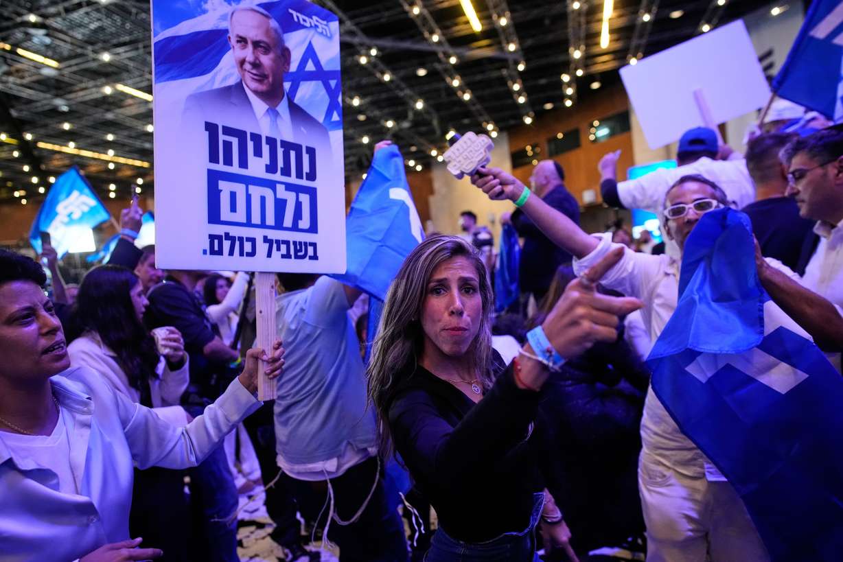 Supporters of Israeli Prime Minister Benjamin Netanyahu celebrate at Likud party headquarters in Jerusalem following the release of the first exit poll results in Israel's general election Wednesday.