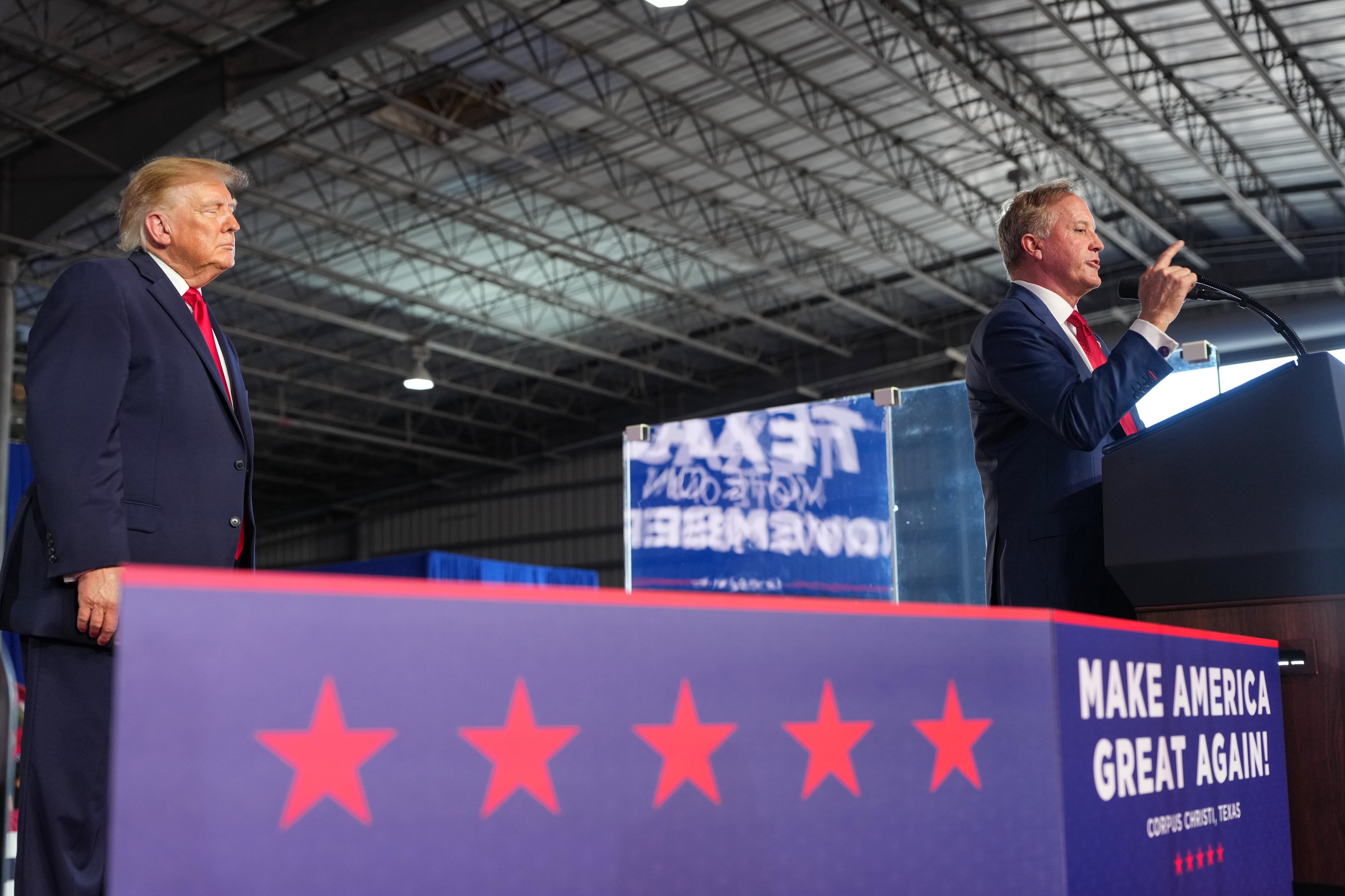 President Donald Trump listens as Senate candidate Texas Attorney General Ken Paxton speaks at a campaign rally at the Port of Corpus Christi, Tuesday, in Corpus Christi, Texas. The question of personality over policy has become elevated in the state's U.S. Senate race.