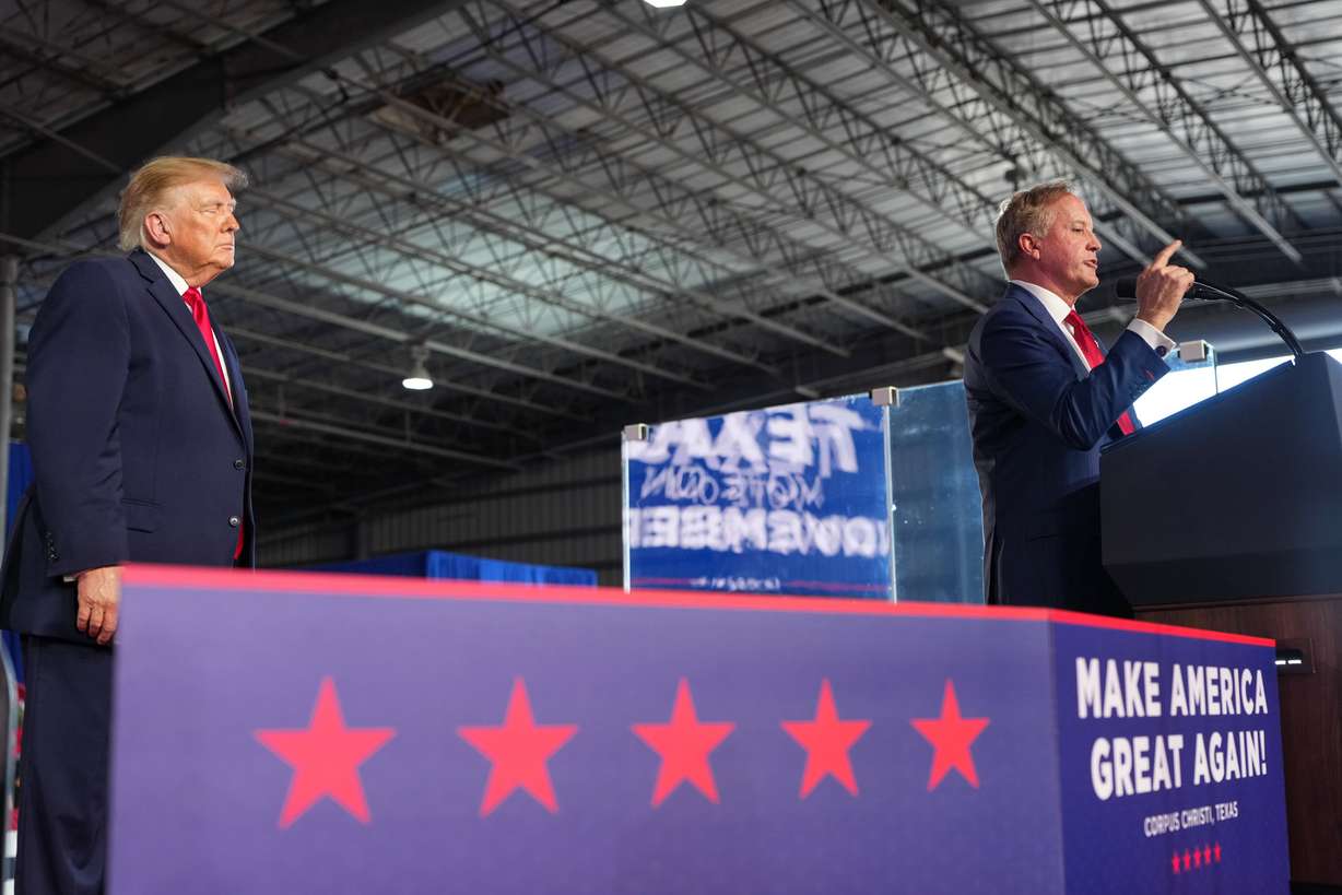 President Donald Trump listens as Senate candidate Texas Attorney General Ken Paxton speaks at a campaign rally at the Port of Corpus Christi, Tuesday, in Corpus Christi, Texas. The question of personality over policy has become elevated in the state's U.S. Senate race.