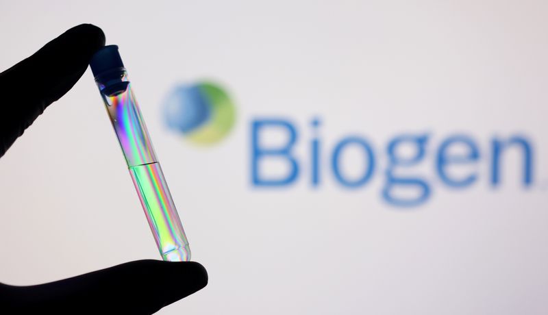 A test tube is seen in front of displayed Biogen logo in this illustration taken, December 1, 2021.