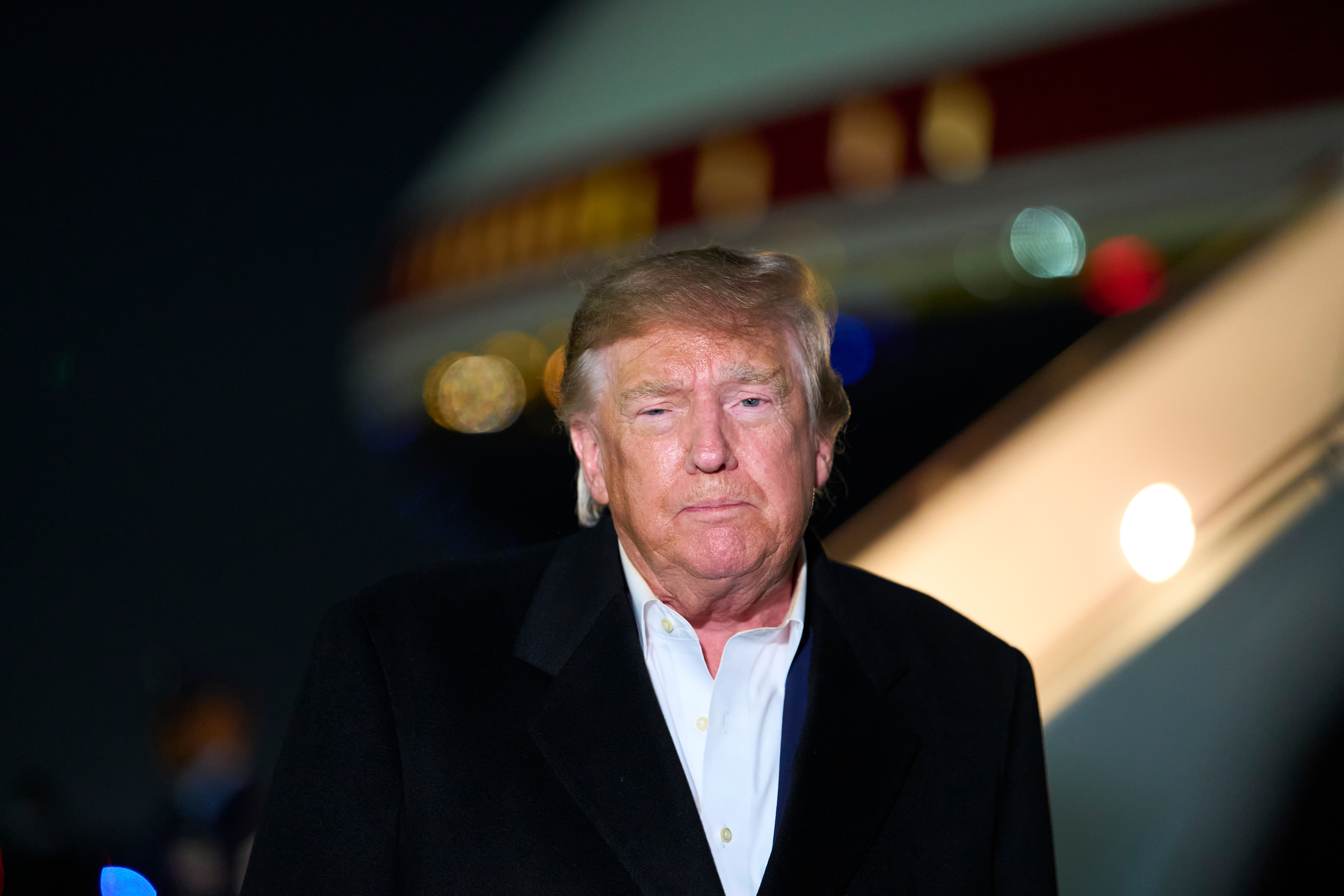 President Donald Trump speaks with reporters as he arrives on Air Force One, Wednesday, at Joint Base Andrews, Md. Trump said he would approve of Flavio Bolsonaro and his family coming to the U.S., calling them "fine people."