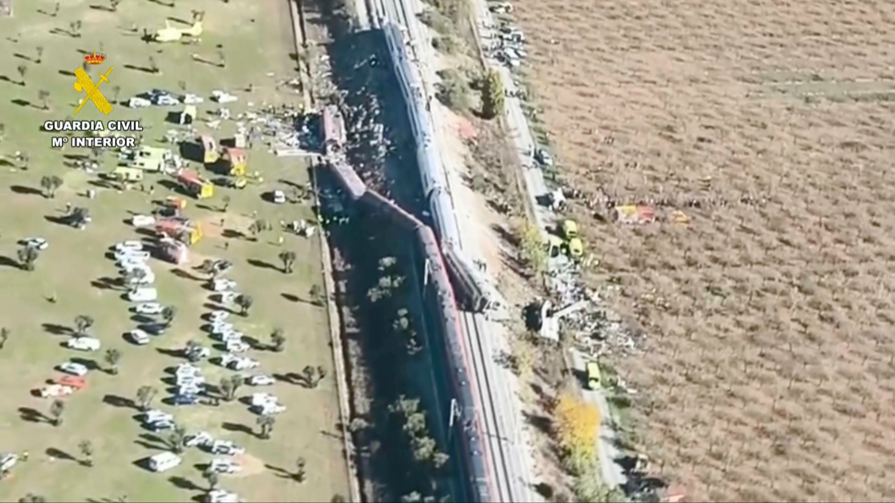 An aerial view of carriages and first responders on the site of a collision between two trains in Urda, Spain, Wednesday. Two cars were derailed, leading to at least 64 people being killed.