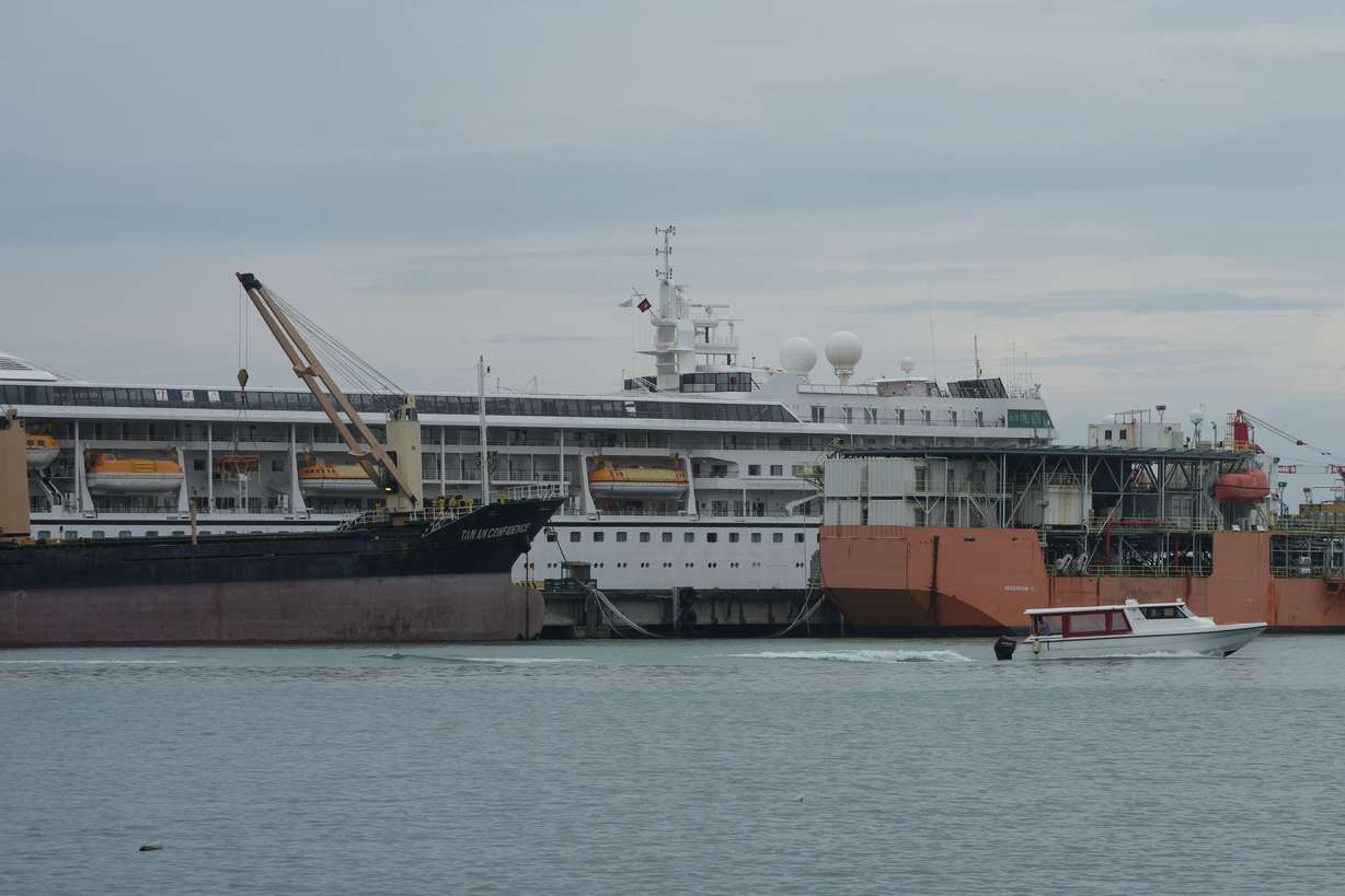 A U.S. cruise ship, the MV Odyssey, docks at the Sihanoukville Autonomous Port in Sihanoukville, Cambodia, Wednesday. The ship suspended its global voyage abruptly due to fuel costs.