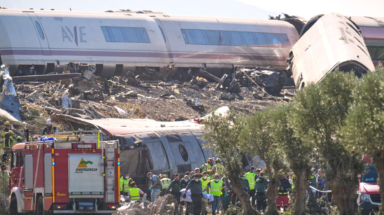 Emergency services work at the scene of a collision between two trains in Urda, Spain, Wednesday, Oct. 28, 2026.