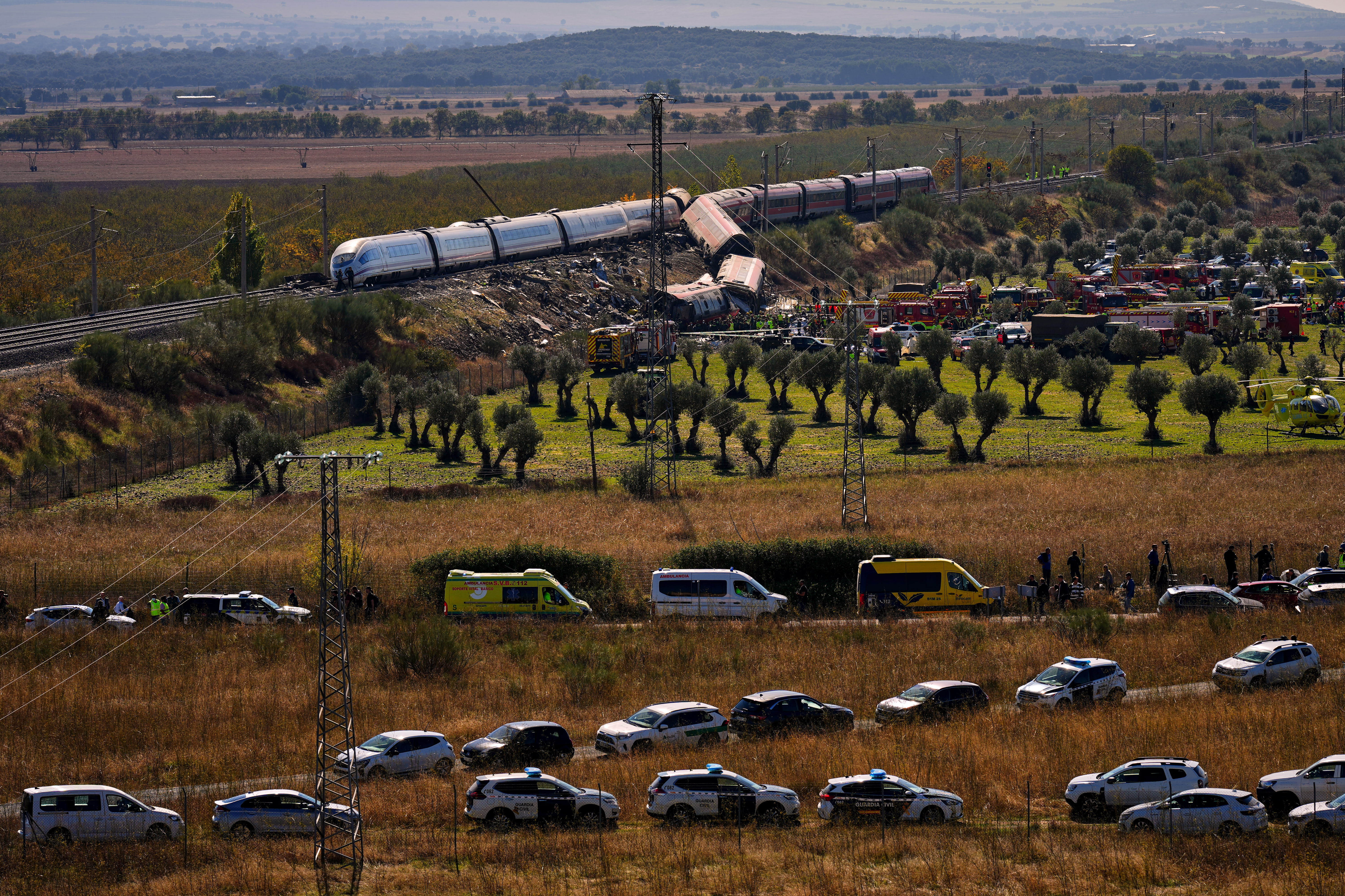 Emergency services work at the scene of a collision between two trains in Urda, Spain, Wednesday. Two cars were derailed, leading to at least 68 people being killed.
