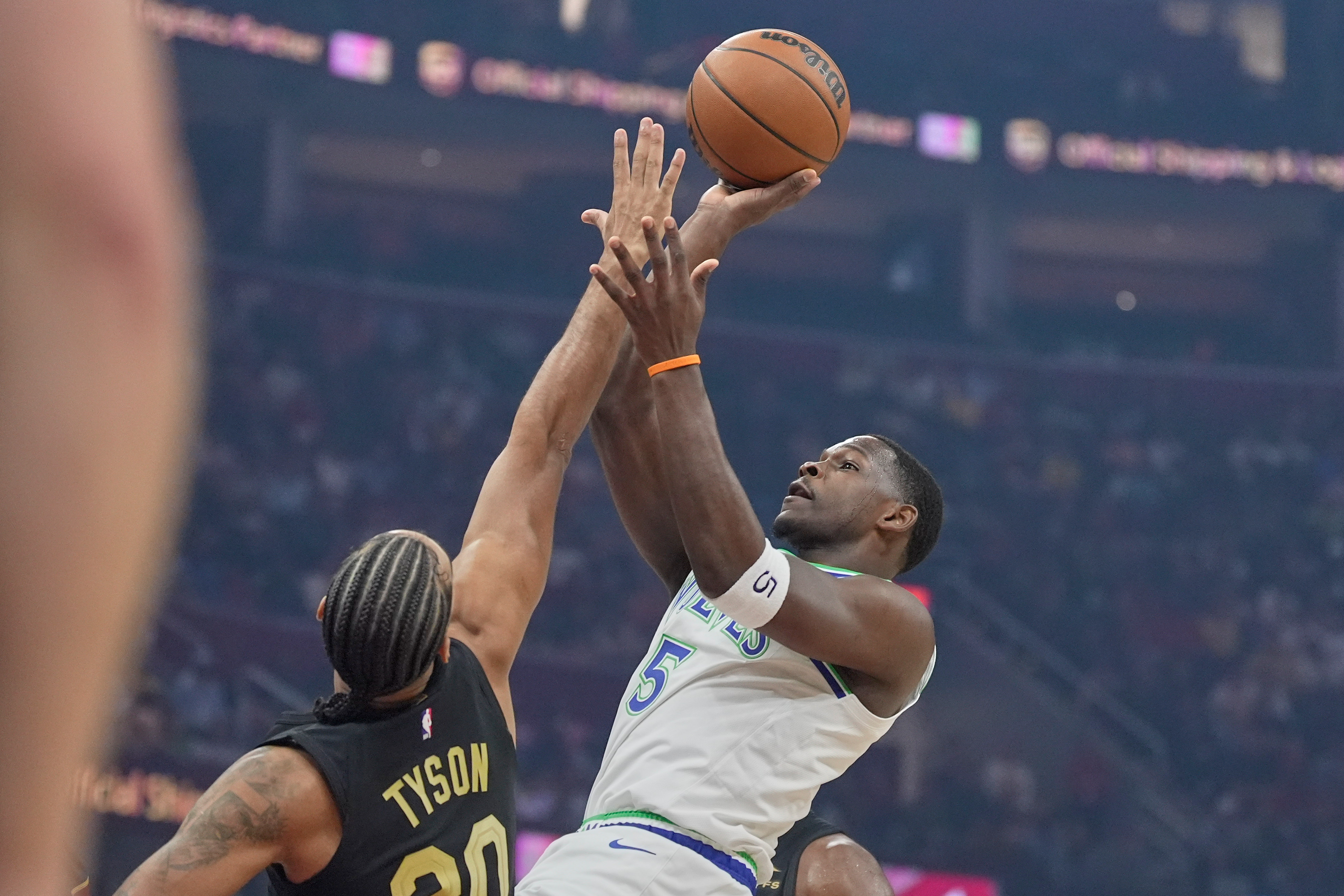 Minnesota Timberwolves guard Anthony Edwards (5) shoots as Cleveland Cavaliers guard Jaylon Tyson (20) defends in the first half of an NBA basketball game, Monday, Oct. 26, 2026, in Cleveland. 