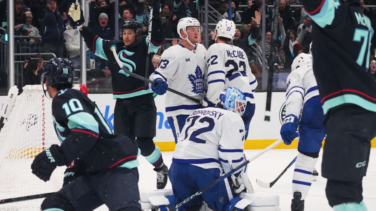 Seattle Kraken defenseman Brandon Montour, second from left, celebrates after making the game-winning goal late during the third period of an NHL hockey game against Toronto Maple Leafs goaltender Sergei Bobrovsky (72), Wednesday, Oct. 28, 2026, in Seattle.